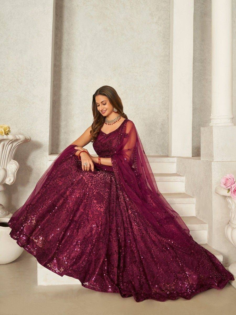 Elegant maroon sequin lehenga choli with sheer dupatta, perfect for weddings and festive occasions.