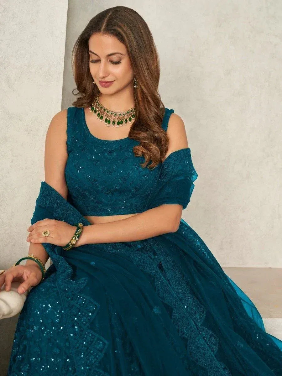 Teal sequined lehenga choli with cold shoulder top, perfect for Indian ethnic wear occasions