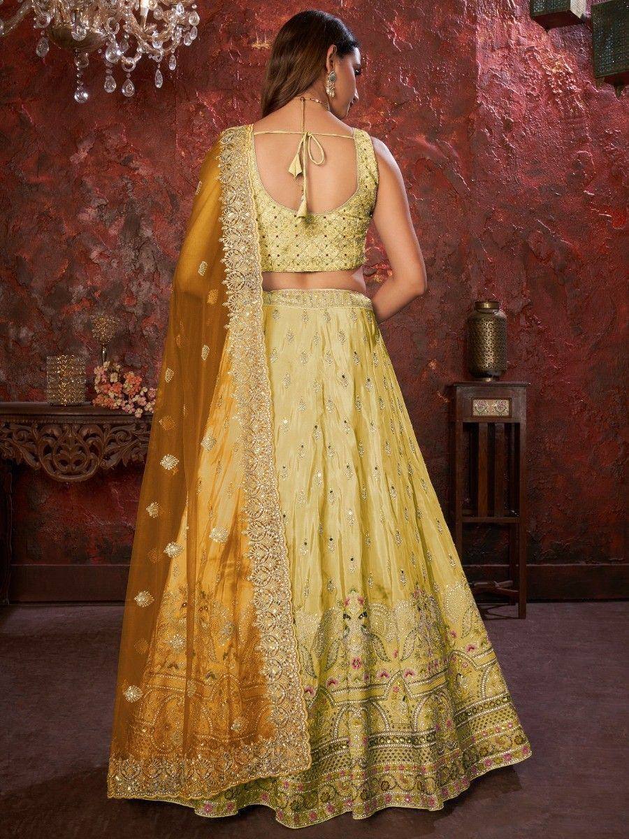 Elegant yellow designer lehenga choli with intricate embroidery and dupatta, perfect for Indian ethnic occasions