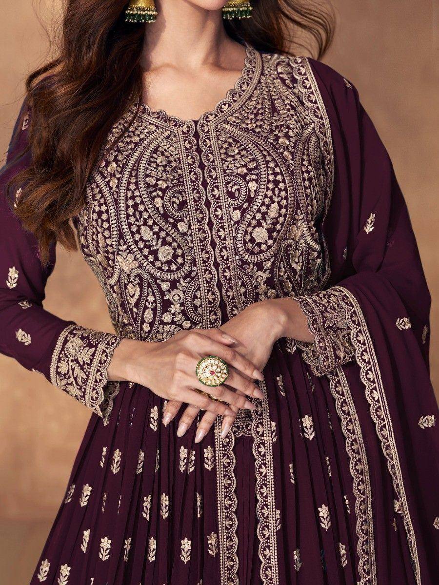 Elegant maroon ethnic gown with gold embroidery, perfect for Indian occasions and festive wear.