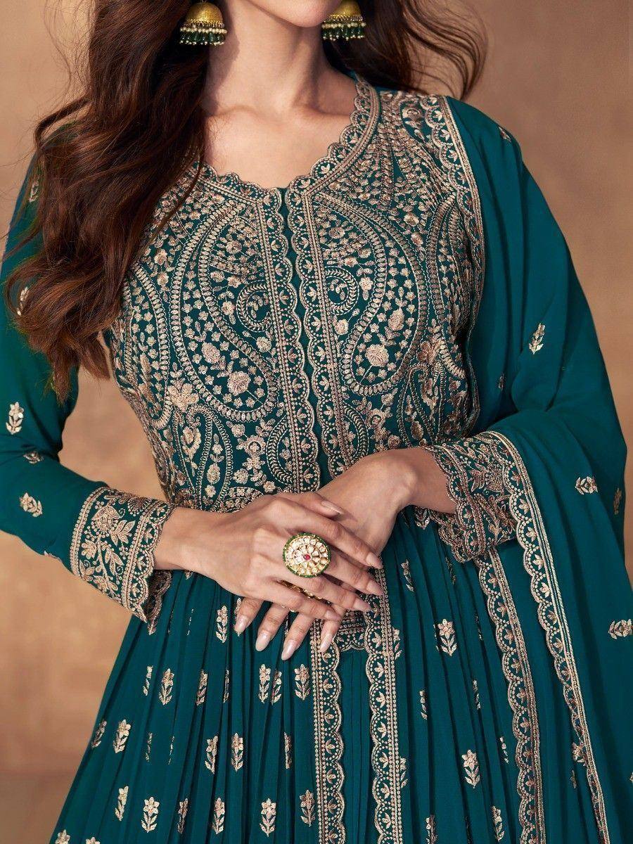 Emerald green ethnic gown with gold embroidery, perfect for Indian occasions and festive wear.
