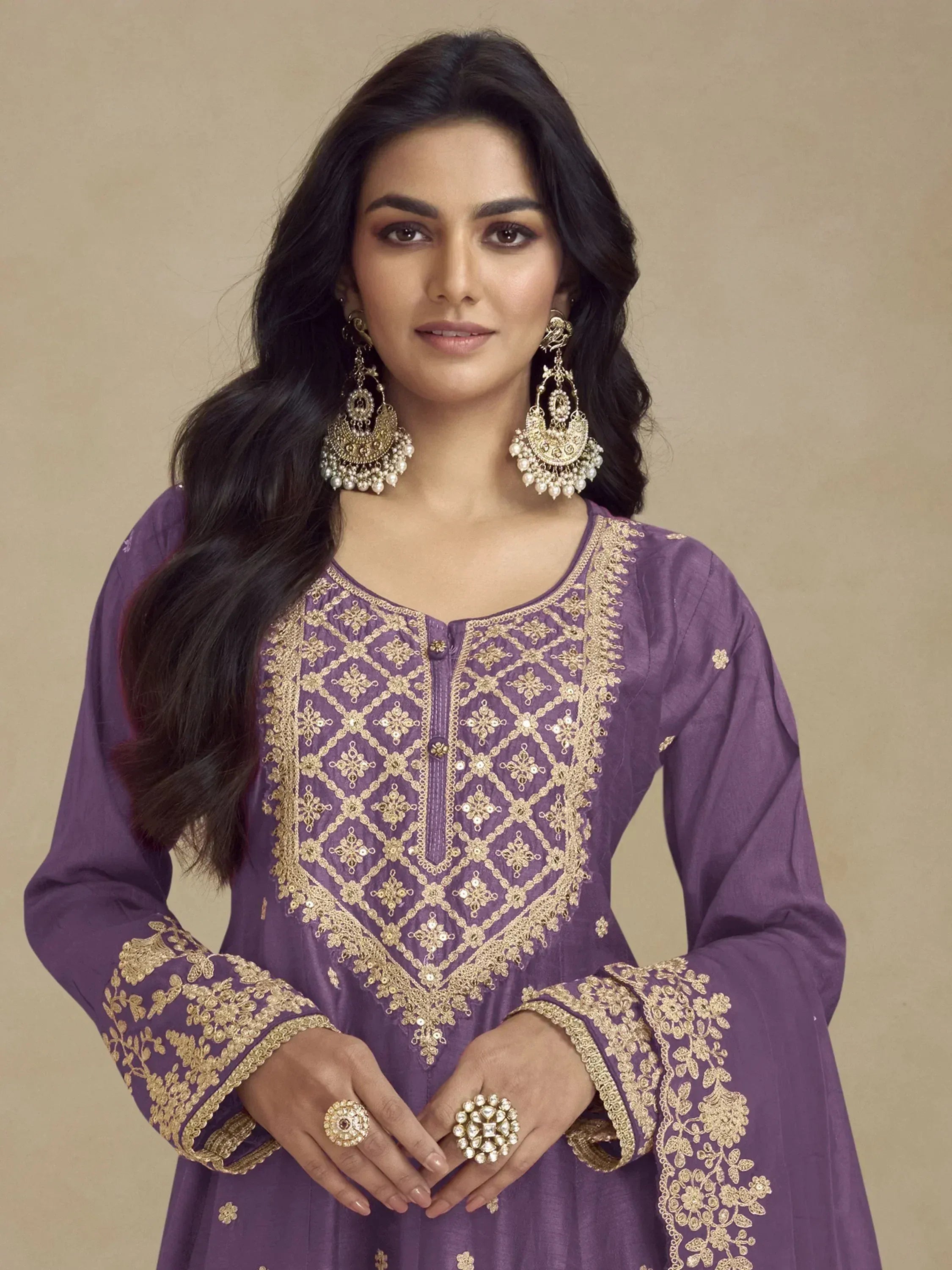 Purple ethnic kurti with gold embroidery, paired with statement earrings and rings for festive occasions