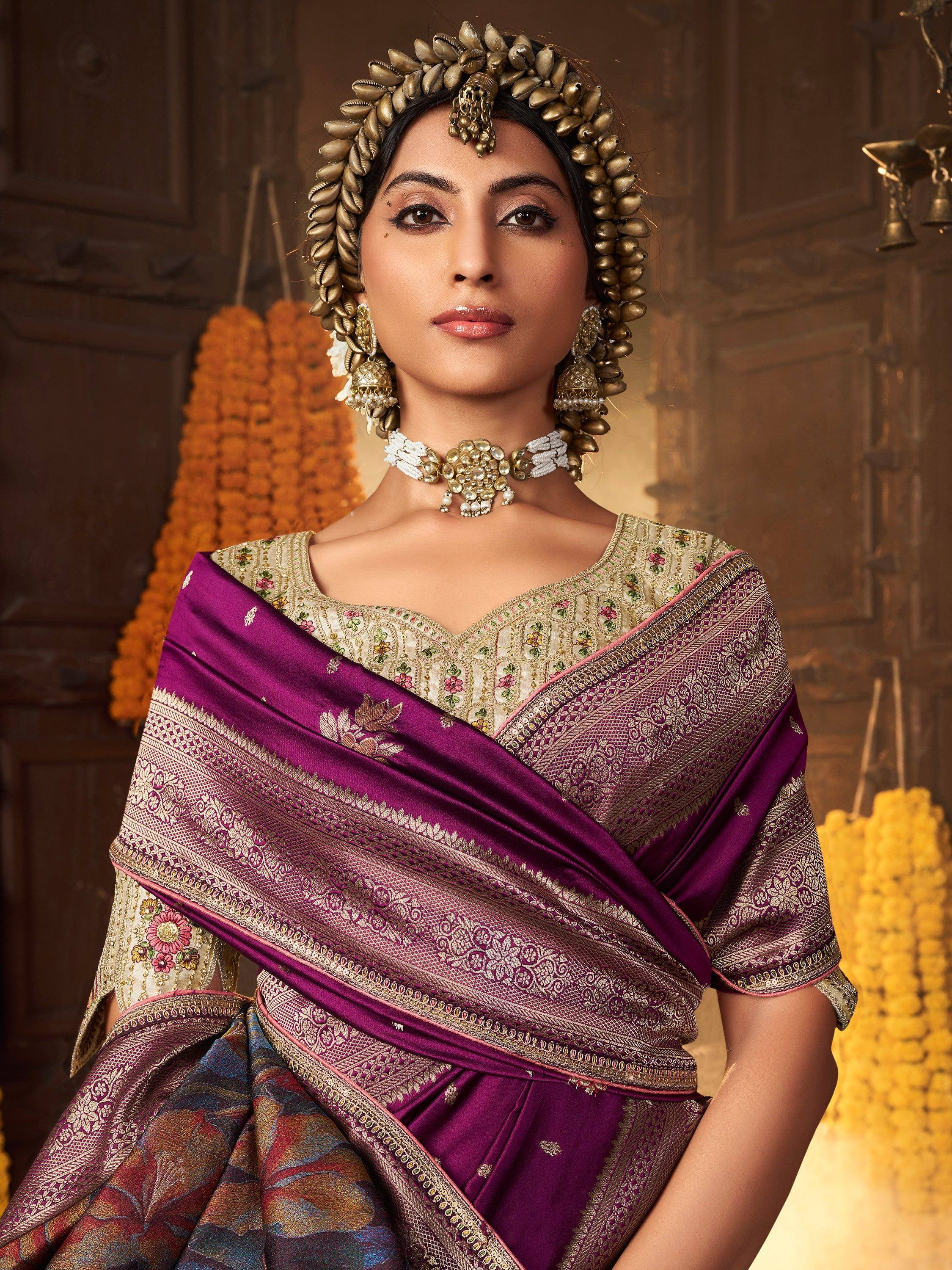 Woman in purple embroidered saree with gold jewelry and traditional Indian headpiece