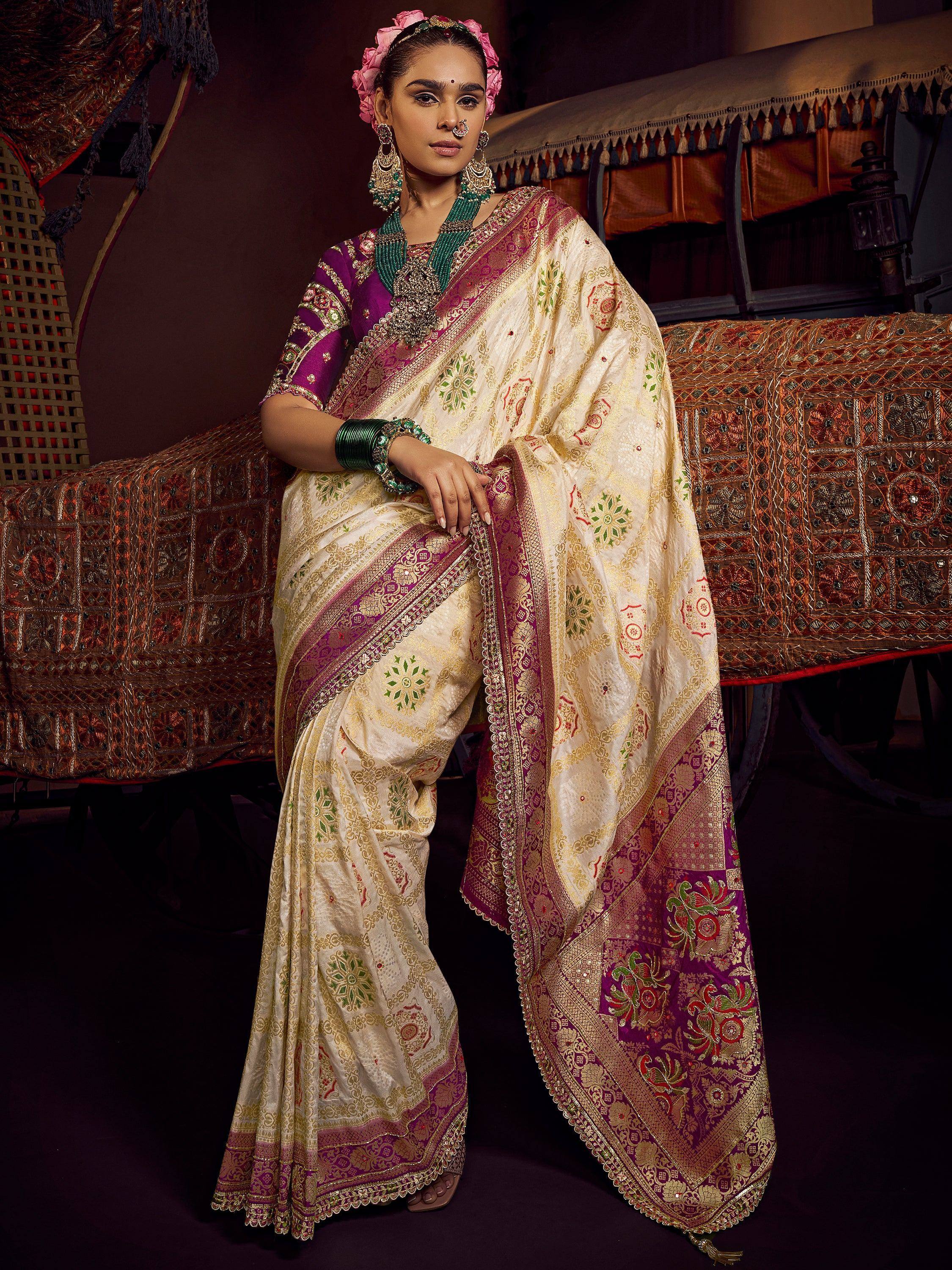 Elegant Indian saree with gold embroidery, purple blouse, and floral motifs for festive occasions.
