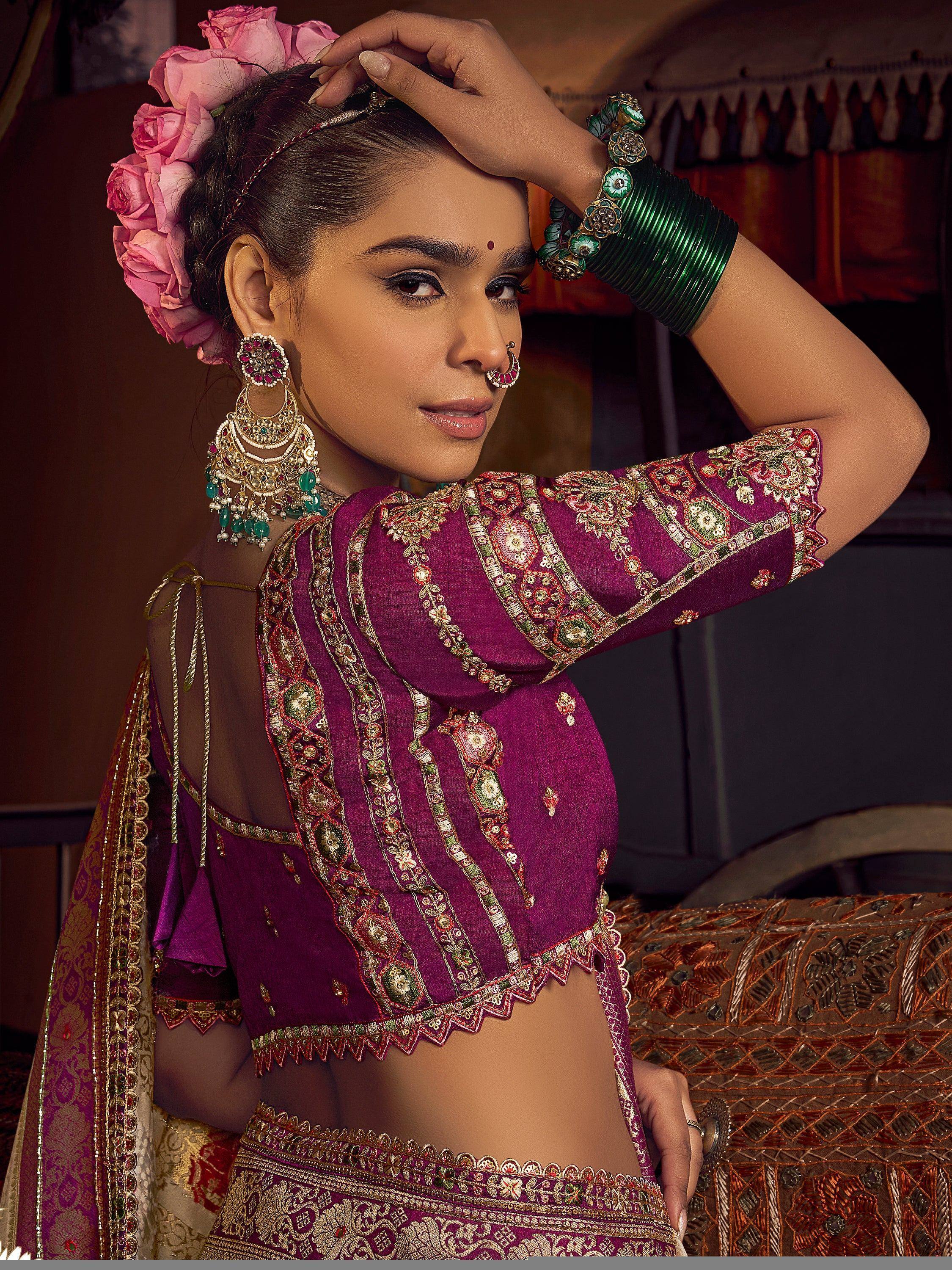 Woman in purple embroidered lehenga choli with floral hair accessory and green bangles, Indian ethnic wear