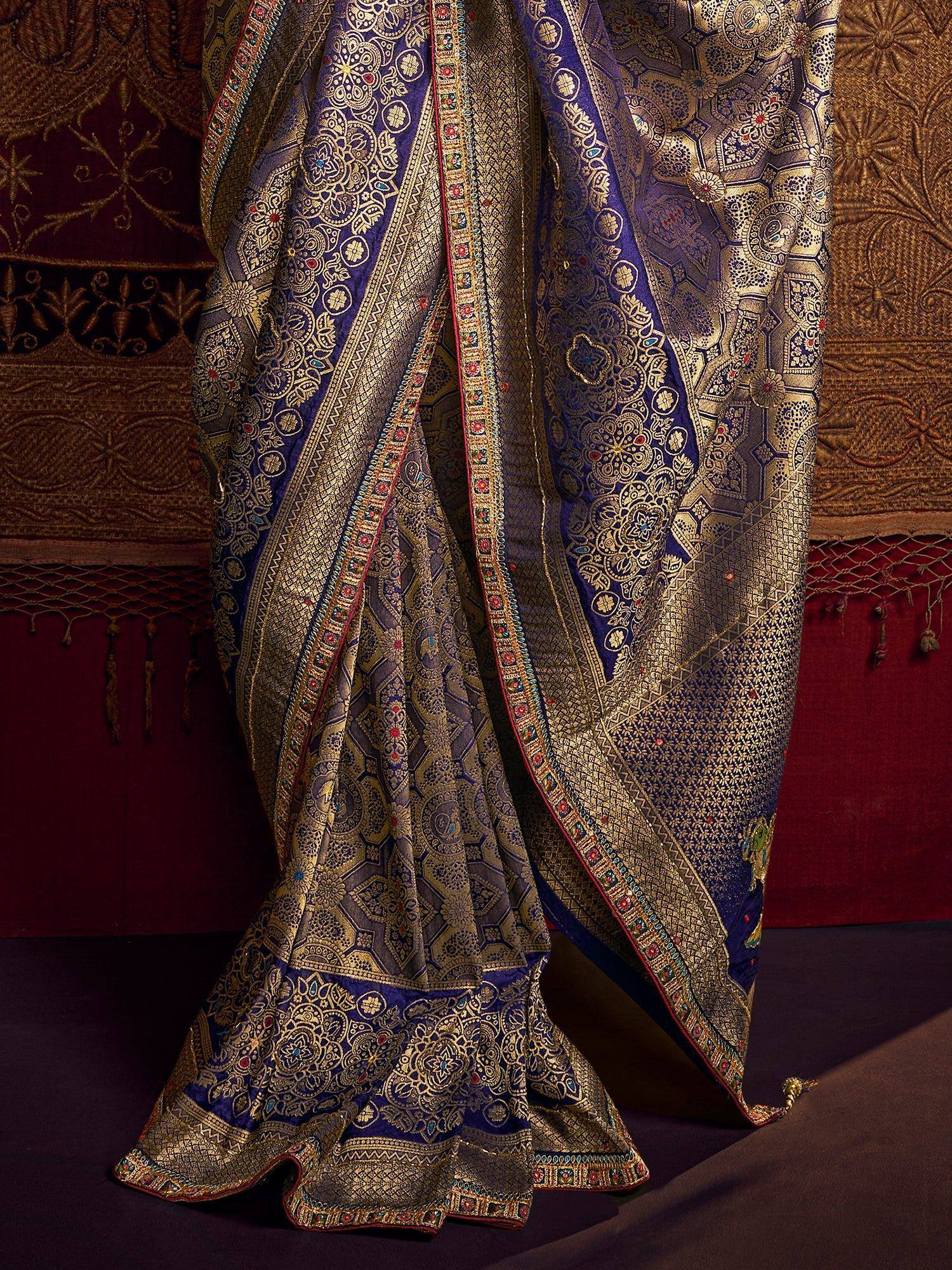 Luxury blue and gold brocade saree with intricate floral and geometric patterns, perfect for Indian ethnic wear.