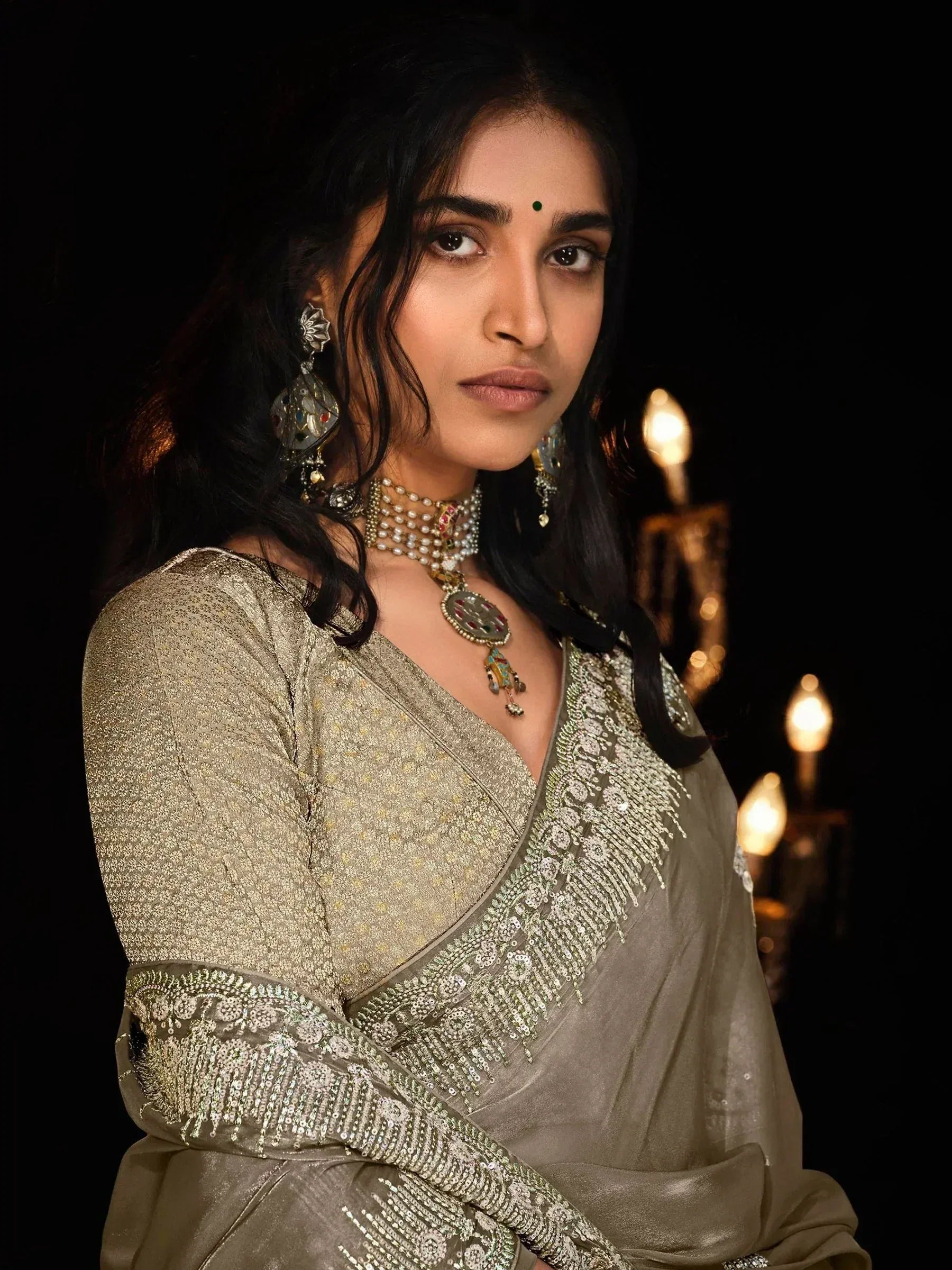 Elegant woman in gold embroidered saree with traditional jewelry, perfect for Indian ethnic wear occasions