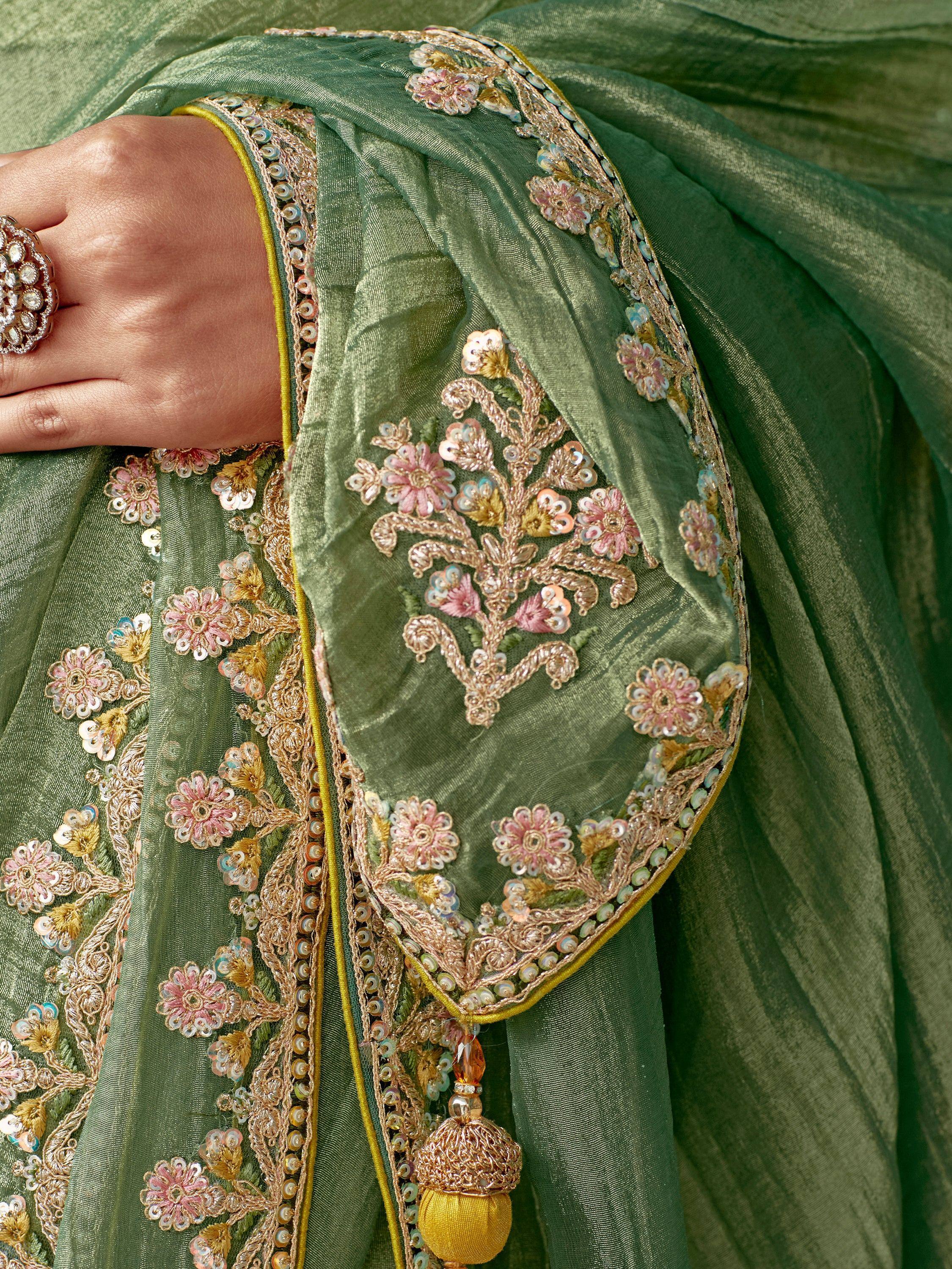 Green ethnic saree with floral embroidery and gold detailing, perfect for Indian occasions.