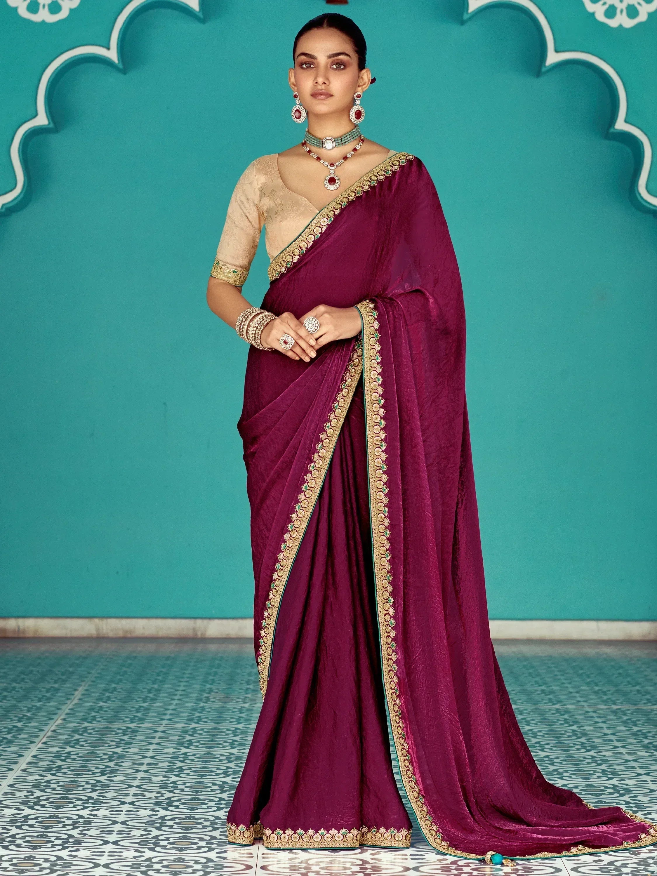 Elegant maroon silk saree with gold embroidery, paired with designer blouse and traditional jewelry for Indian ethnic wear