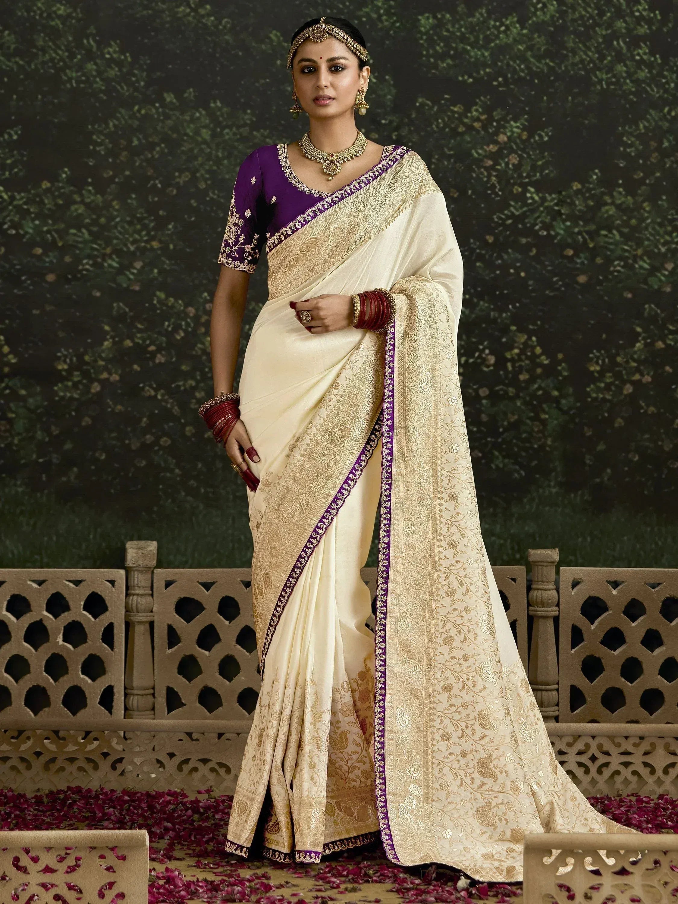 Elegant cream saree with gold embroidery and purple blouse, perfect for Indian ethnic occasions