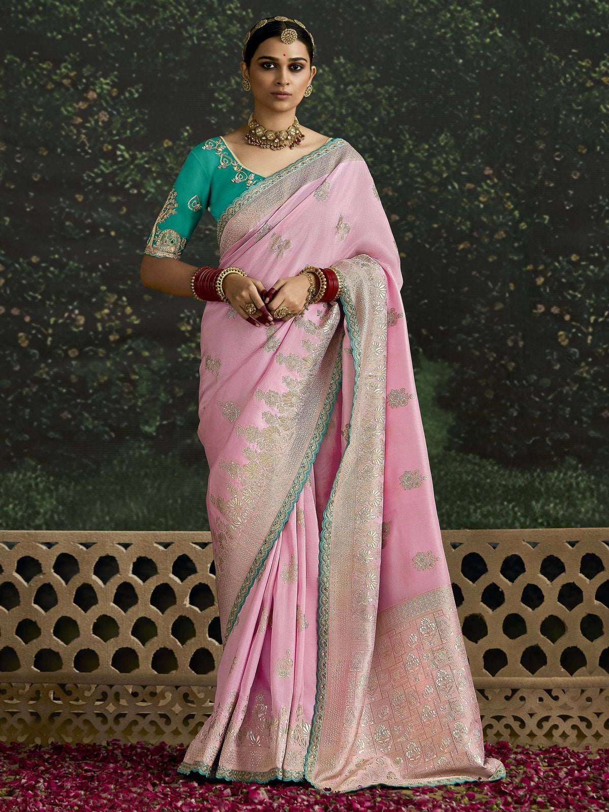 Pink embroidered saree with teal blouse, gold jewelry, perfect for Indian ethnic wear occasions