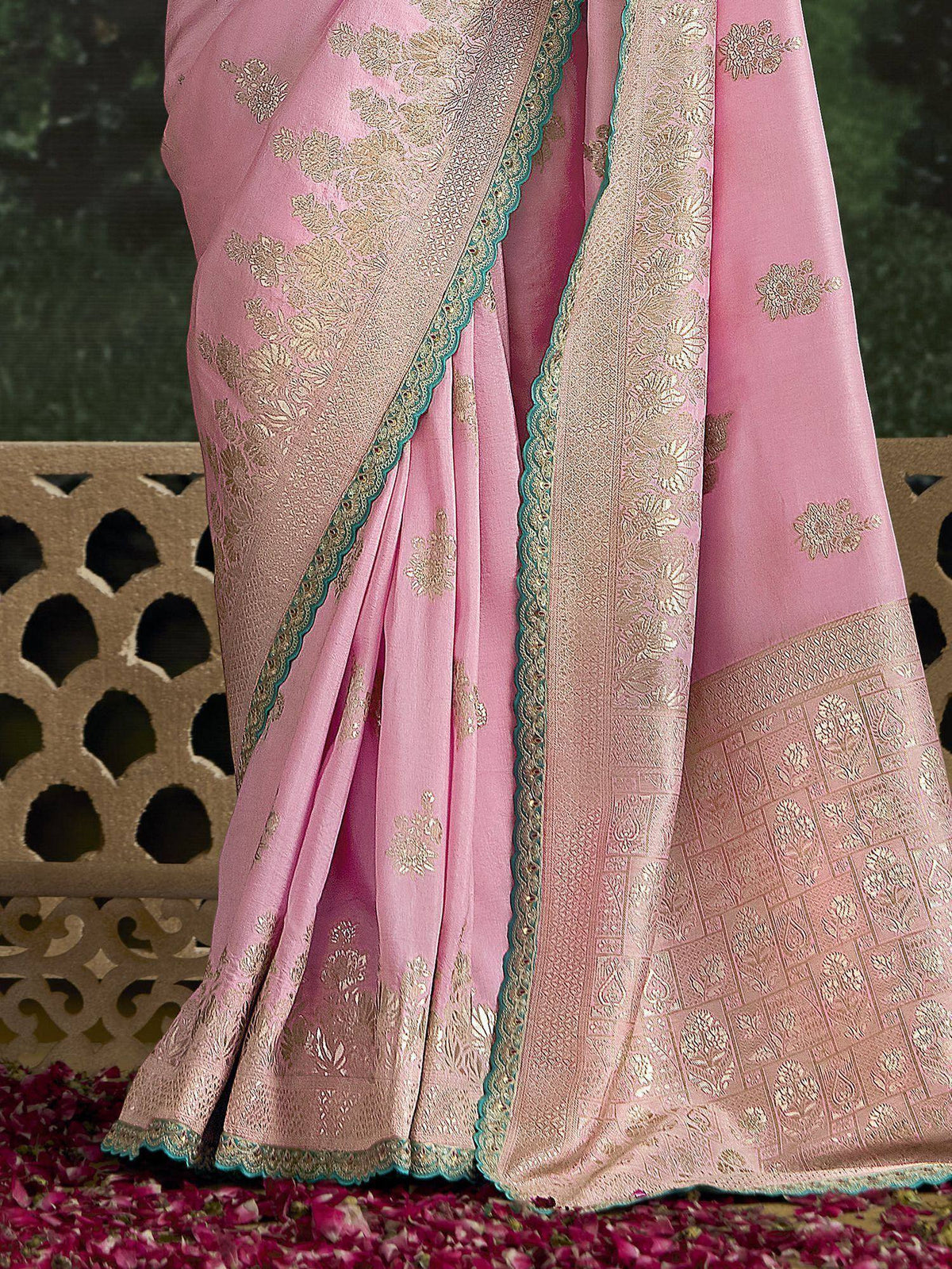 Pink designer saree with gold floral embroidery and teal border, perfect for Indian ethnic occasions