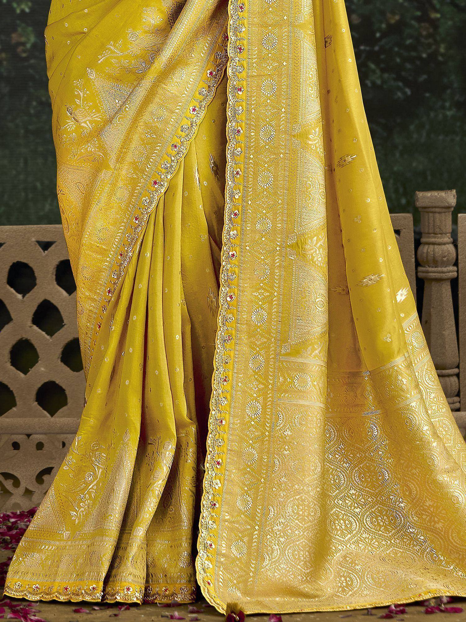 Yellow designer saree with intricate gold embroidery and floral border, perfect for ethnic occasions