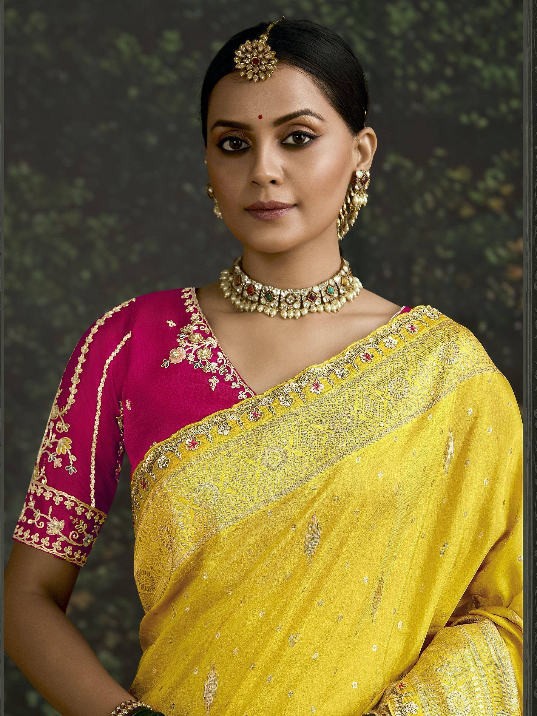 Yellow saree with pink blouse, gold embroidery, and traditional Indian jewelry for ethnic wear
