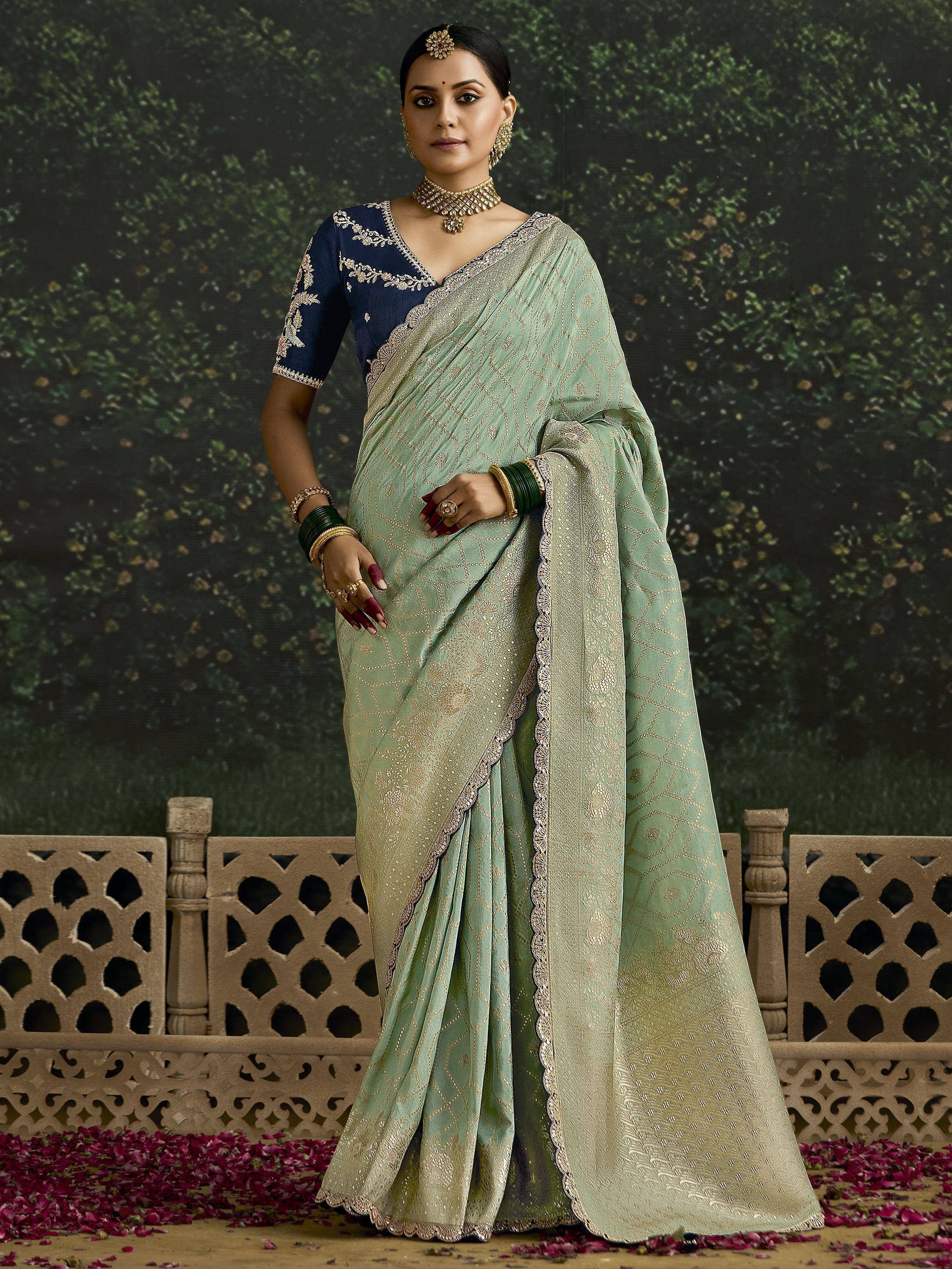 Mint green designer saree with gold embroidery, paired with navy blue blouse, perfect for Indian ethnic occasions
