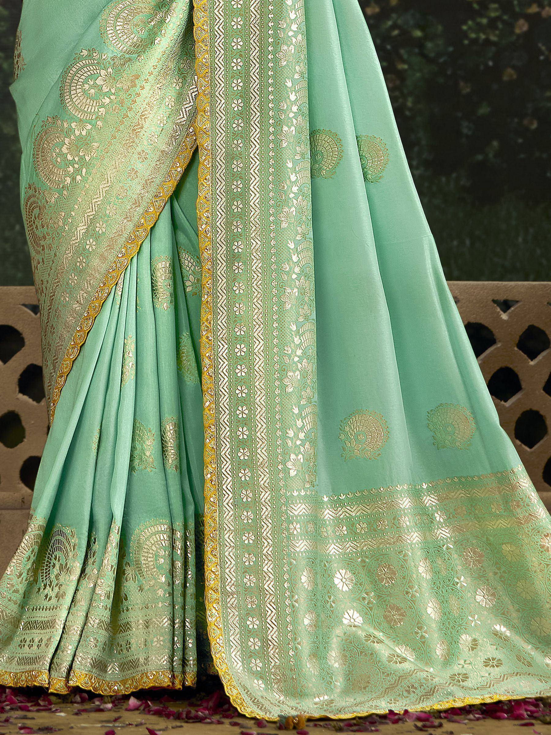 Mint green designer saree with gold zari embroidery and floral motifs, perfect for Indian ethnic occasions