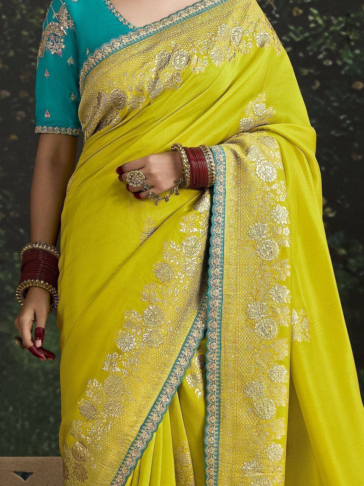 Yellow saree with gold floral embroidery and teal blouse, ethnic Indian wear