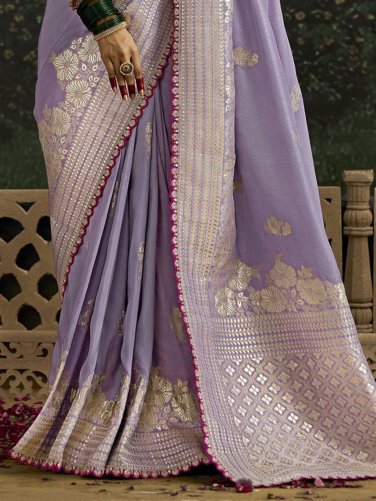 Lavender saree with gold floral embroidery and pink border, styled with green bangles and ring