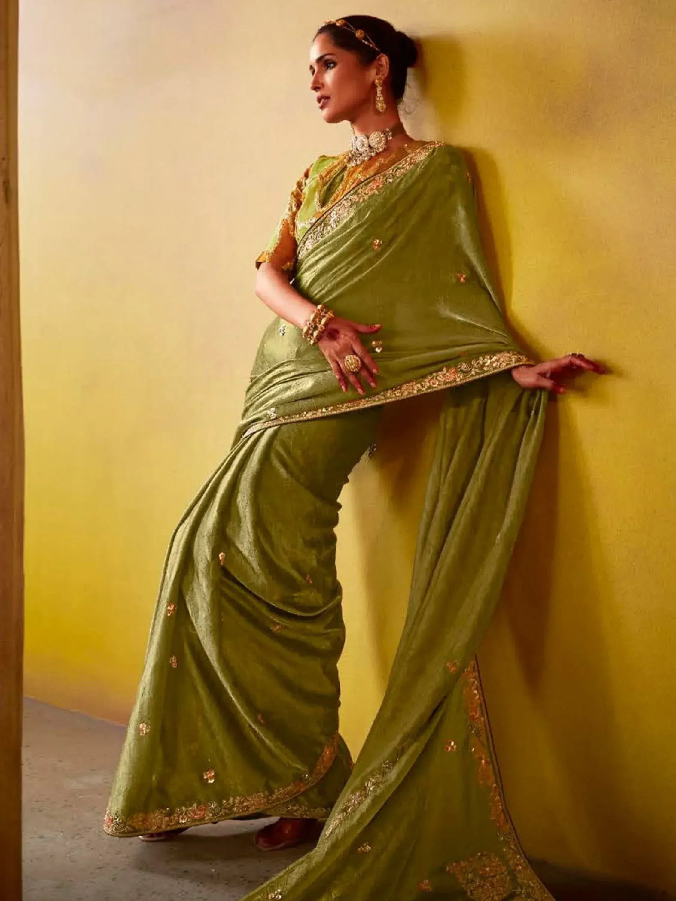 Elegant olive green saree with gold embroidery, perfect for Indian ethnic wear occasions.