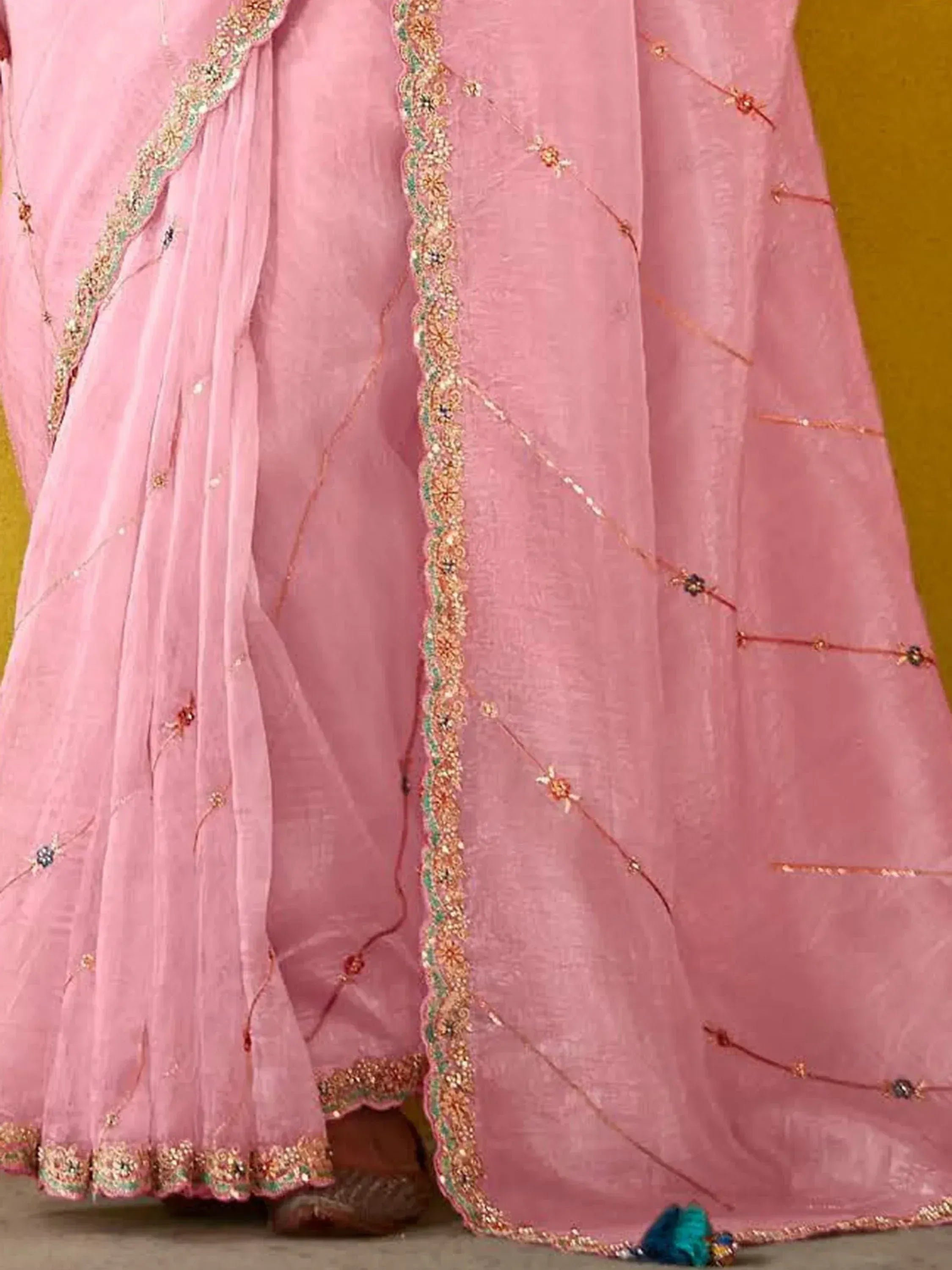 Pink embroidered lehenga choli with gold and green detailing, perfect for Indian ethnic wear occasions.