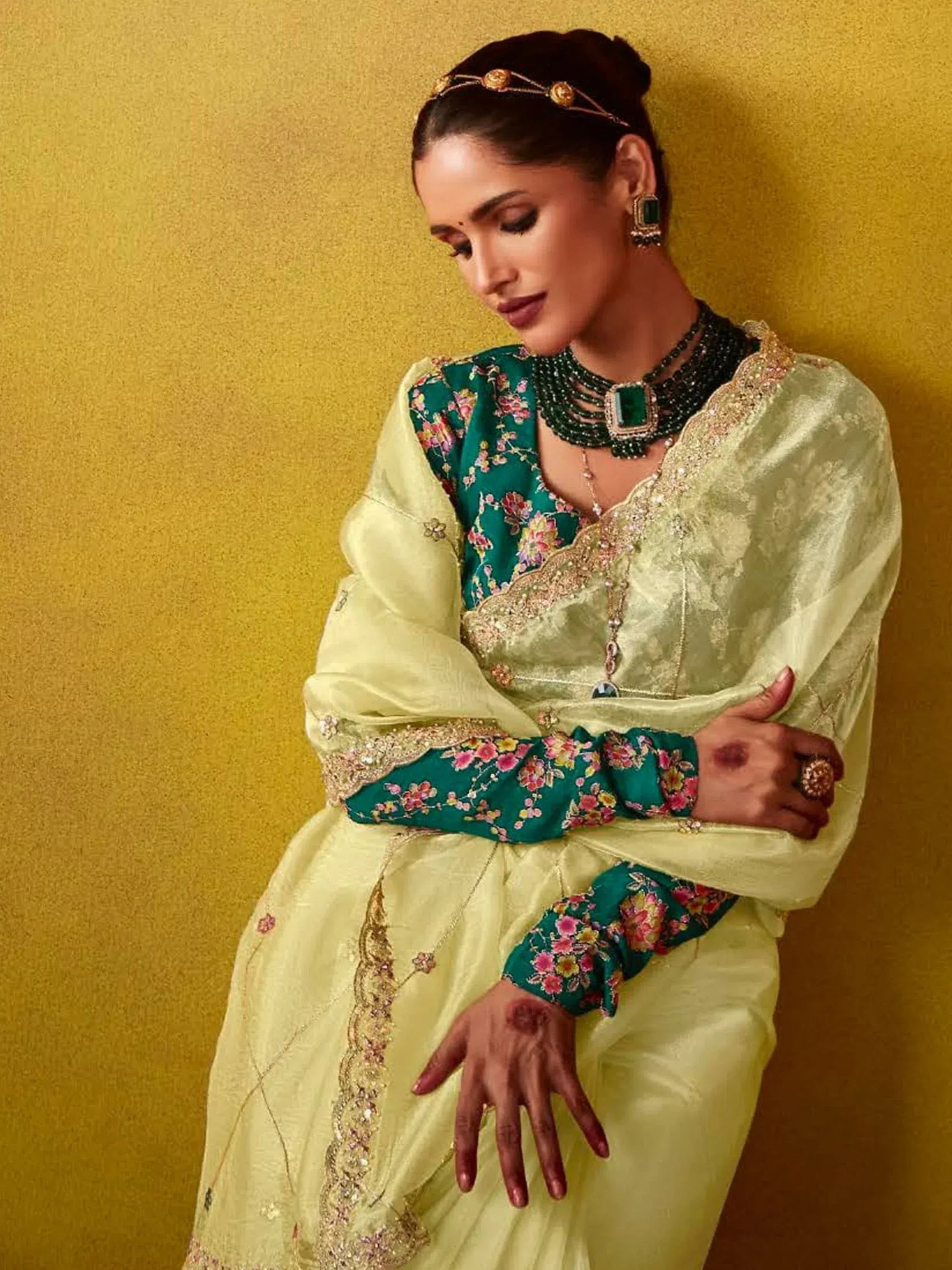 Elegant Indian ethnic wear: floral green and gold salwar kameez with traditional jewelry, perfect for festive occasions.