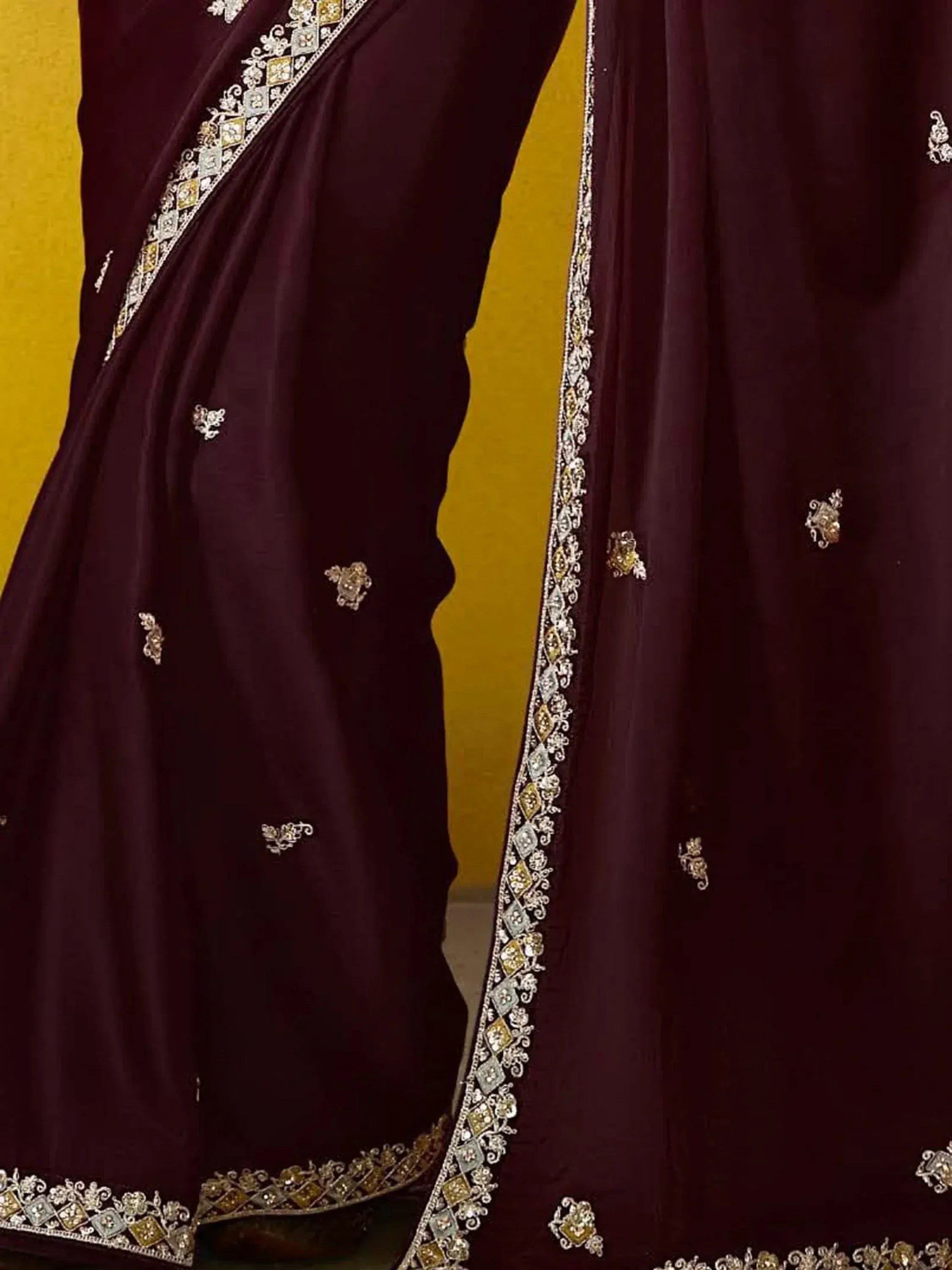 Elegant maroon saree with intricate gold and silver embroidery, perfect for Indian ethnic wear occasions.