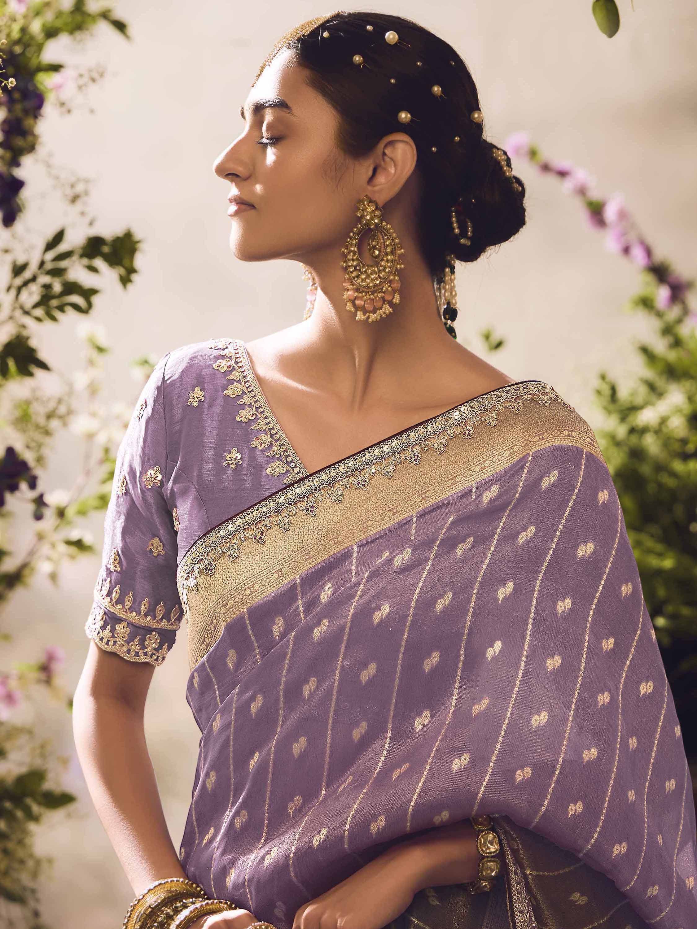 Purple saree with gold embroidery and border, styled with traditional jewelry for Indian ethnic wear