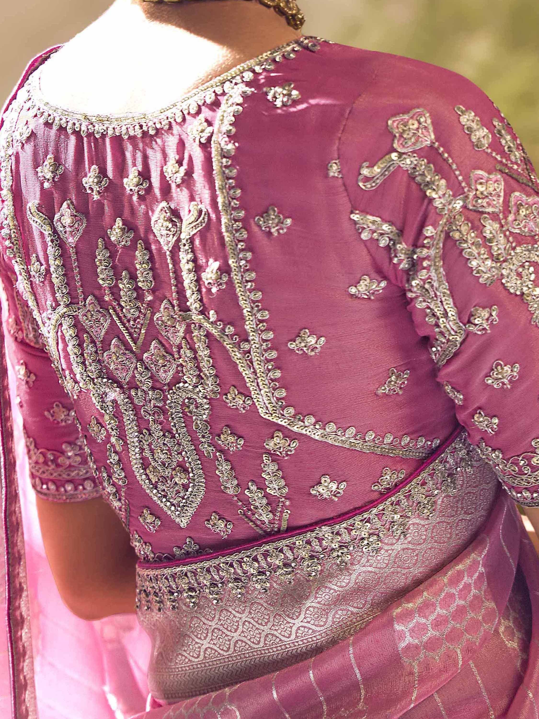Pink designer lehenga choli with intricate gold embroidery and detailed back neckline