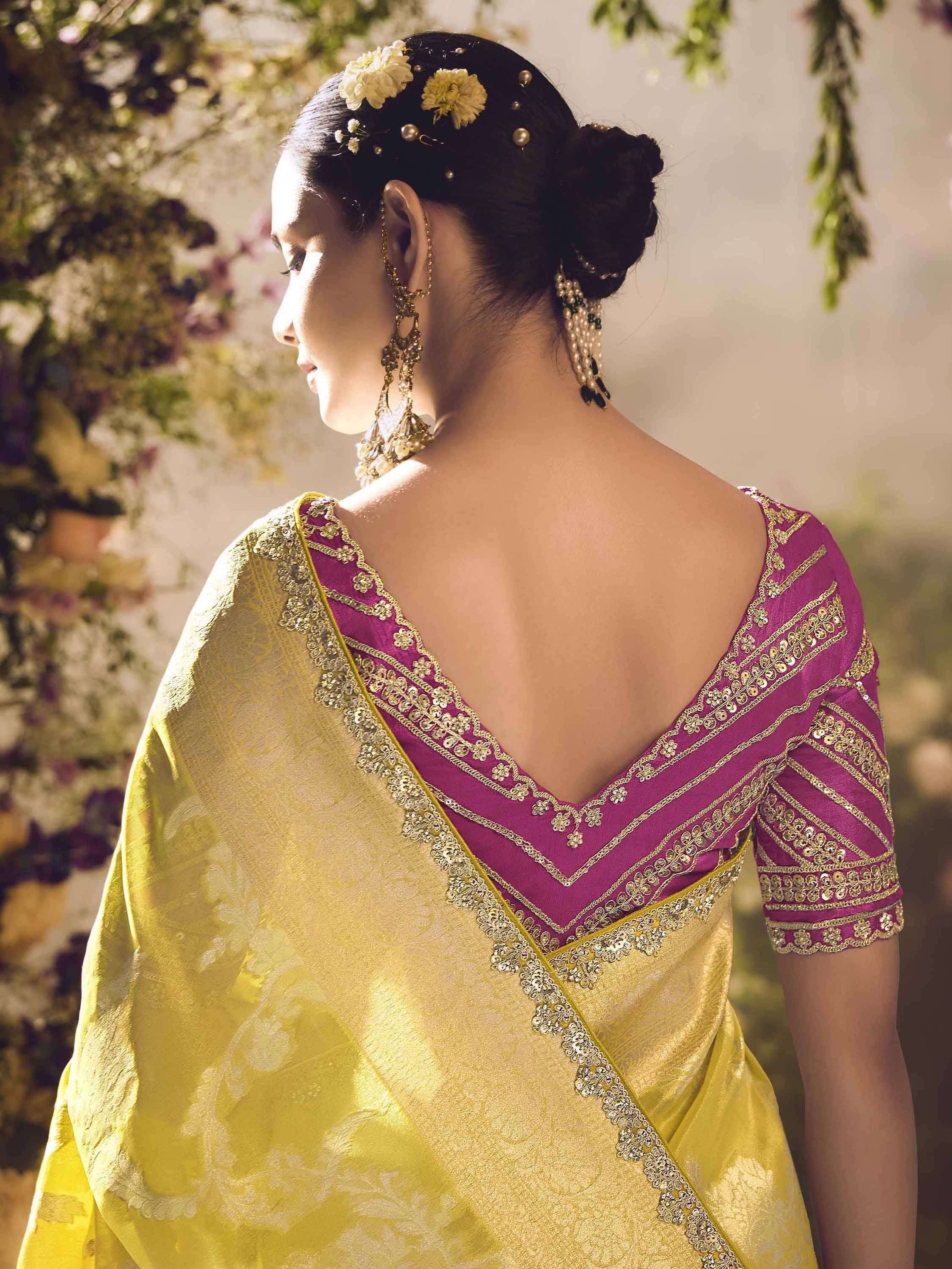 Elegant yellow saree with purple blouse, gold embroidery, and floral hair accessories for Indian ethnic wear