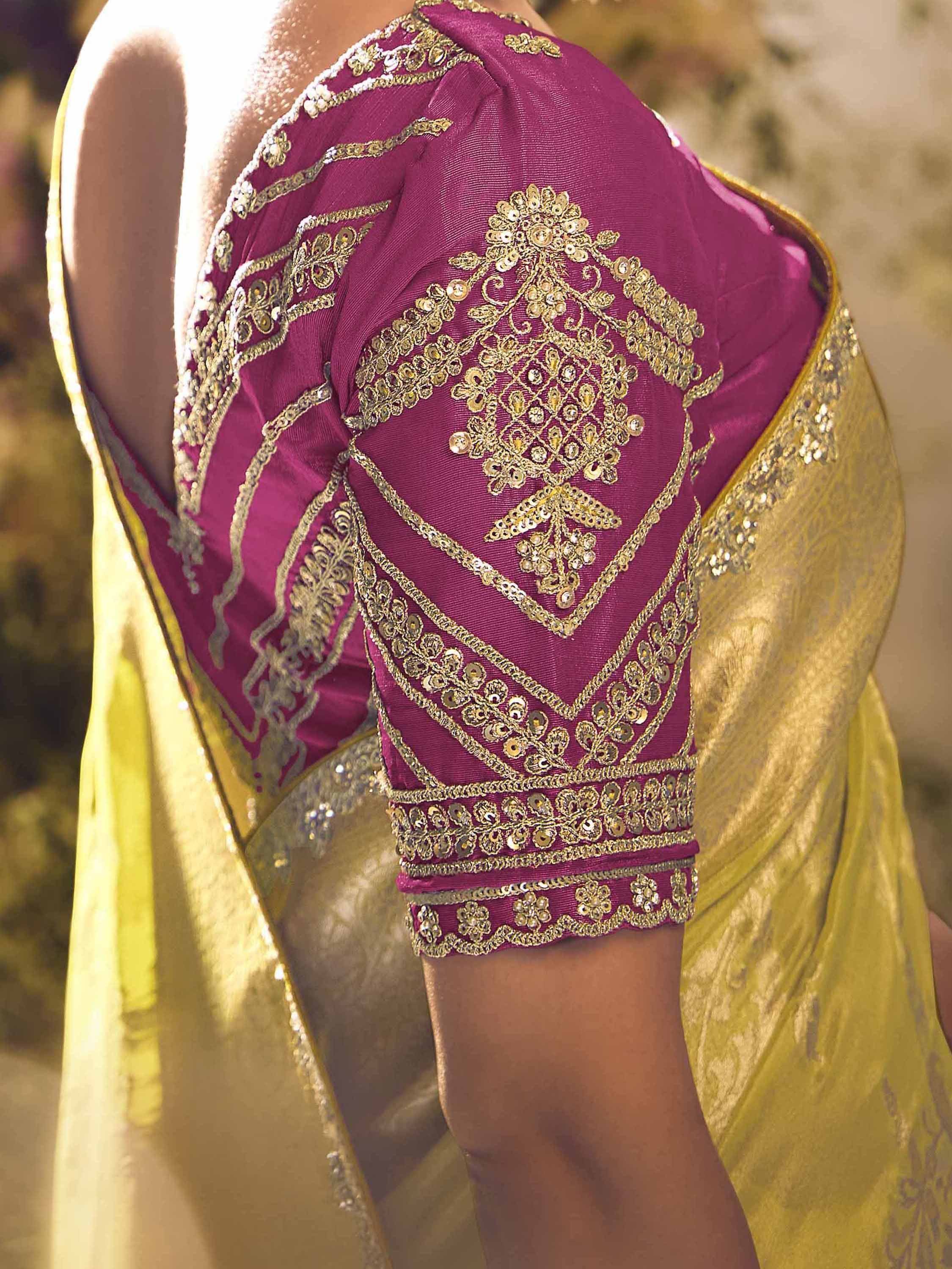 Purple ethnic blouse with gold embroidery and sequins, paired with yellow saree, showcasing designer Indian wear details.