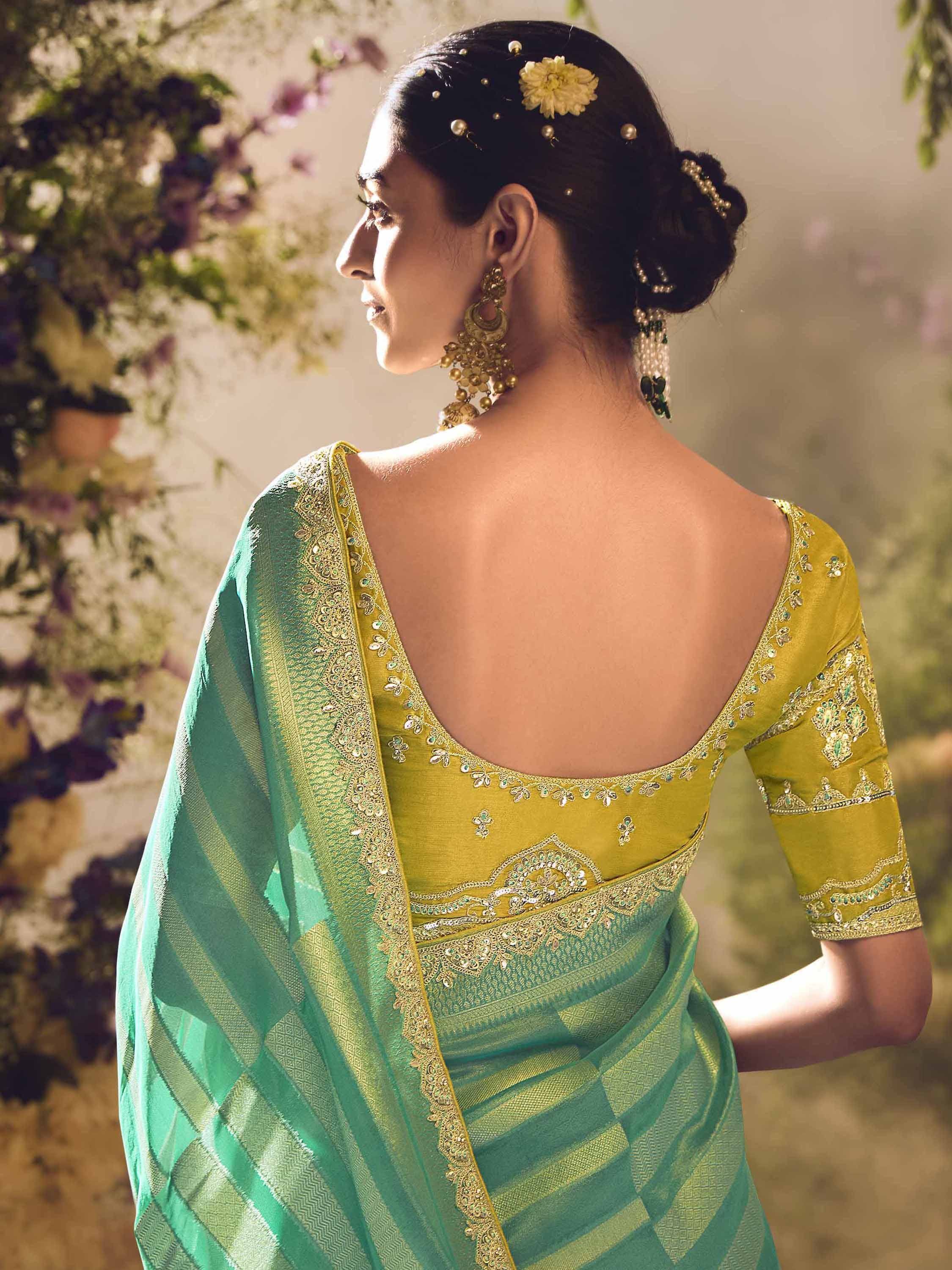 Elegant green and gold saree with embroidered back blouse, perfect for Indian ethnic wear occasions.