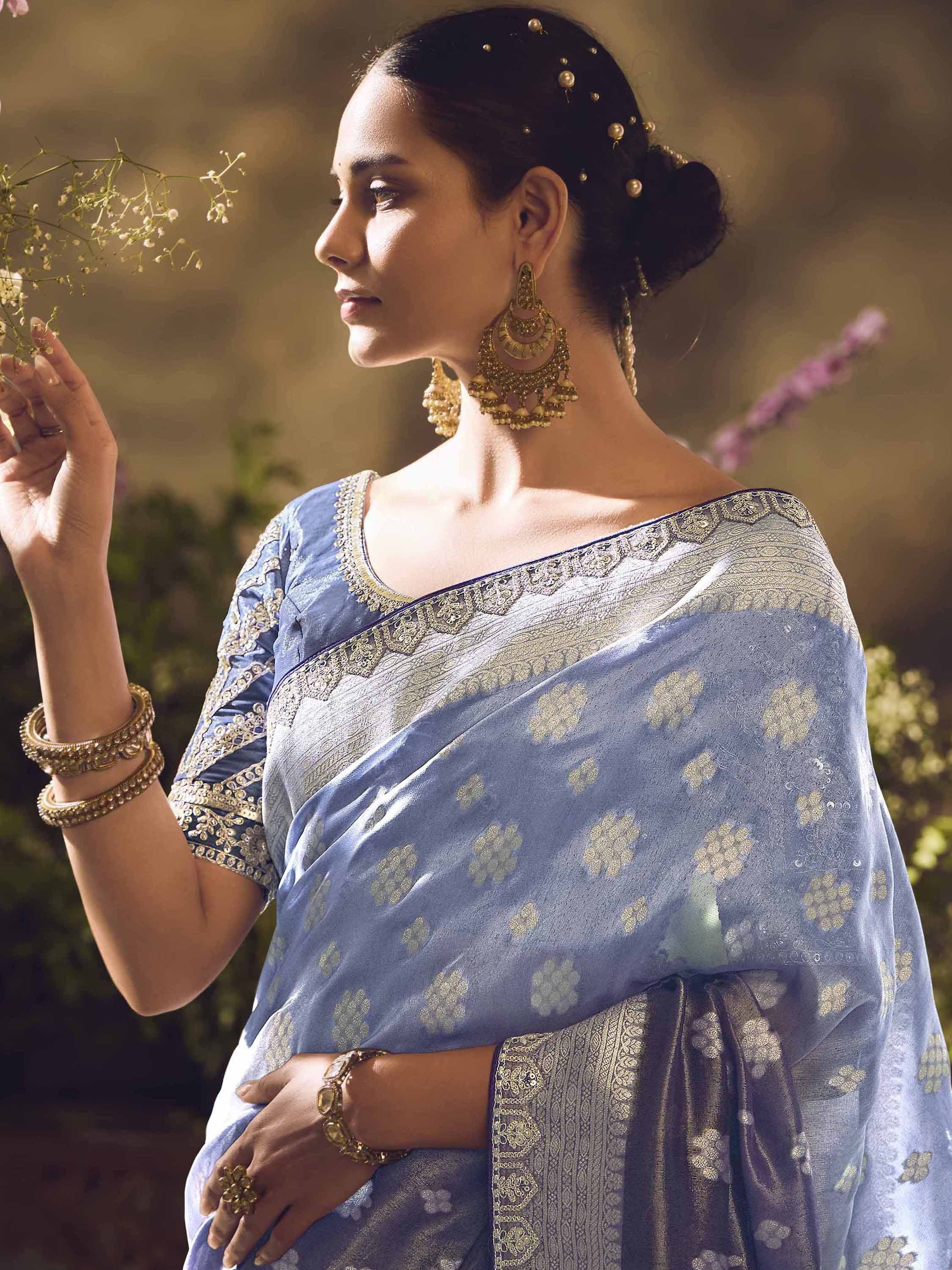 Elegant woman in blue floral saree with gold embroidery, traditional Indian ethnic wear