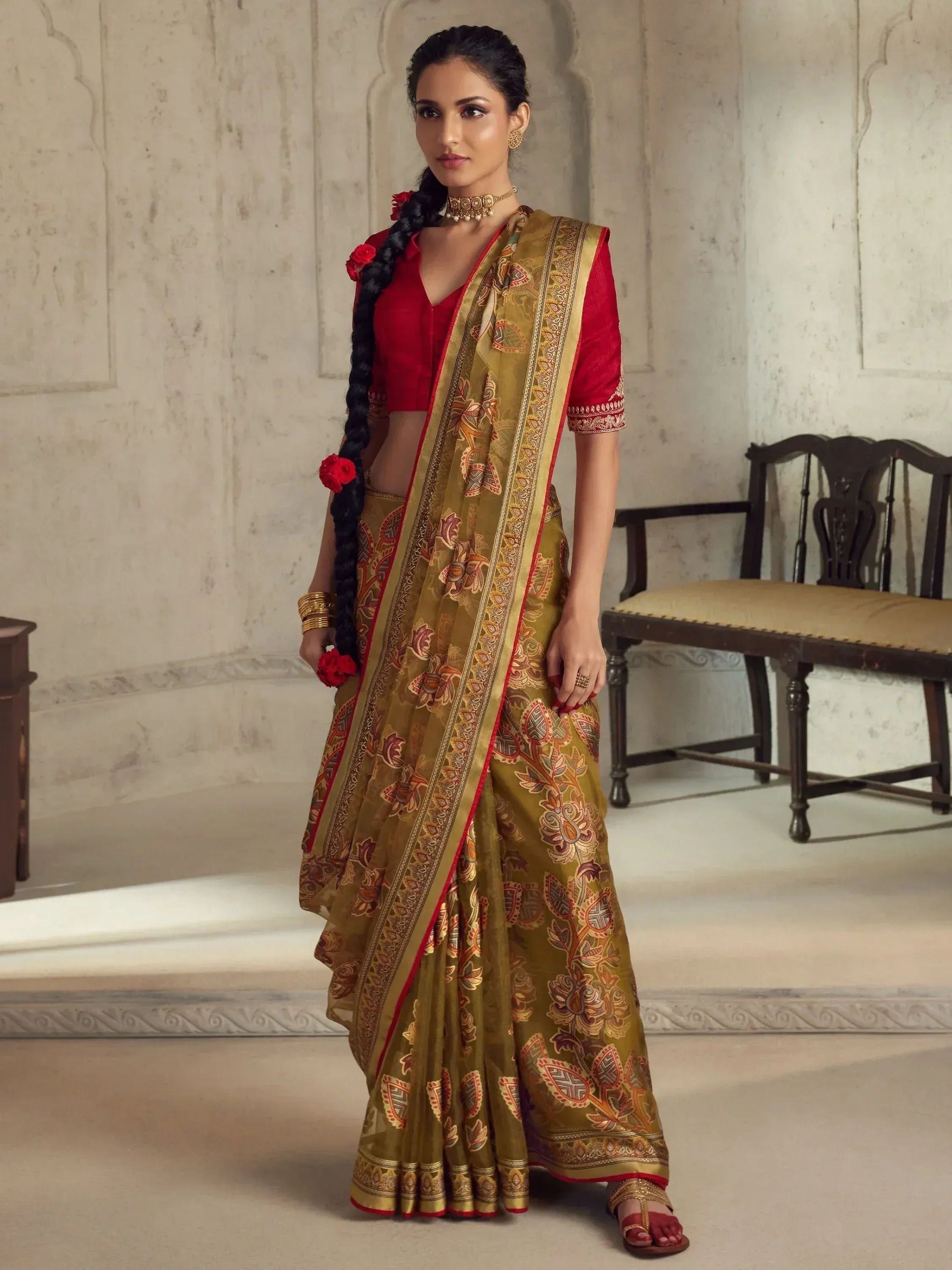 Woman in olive green floral saree with red blouse, traditional Indian ethnic wear