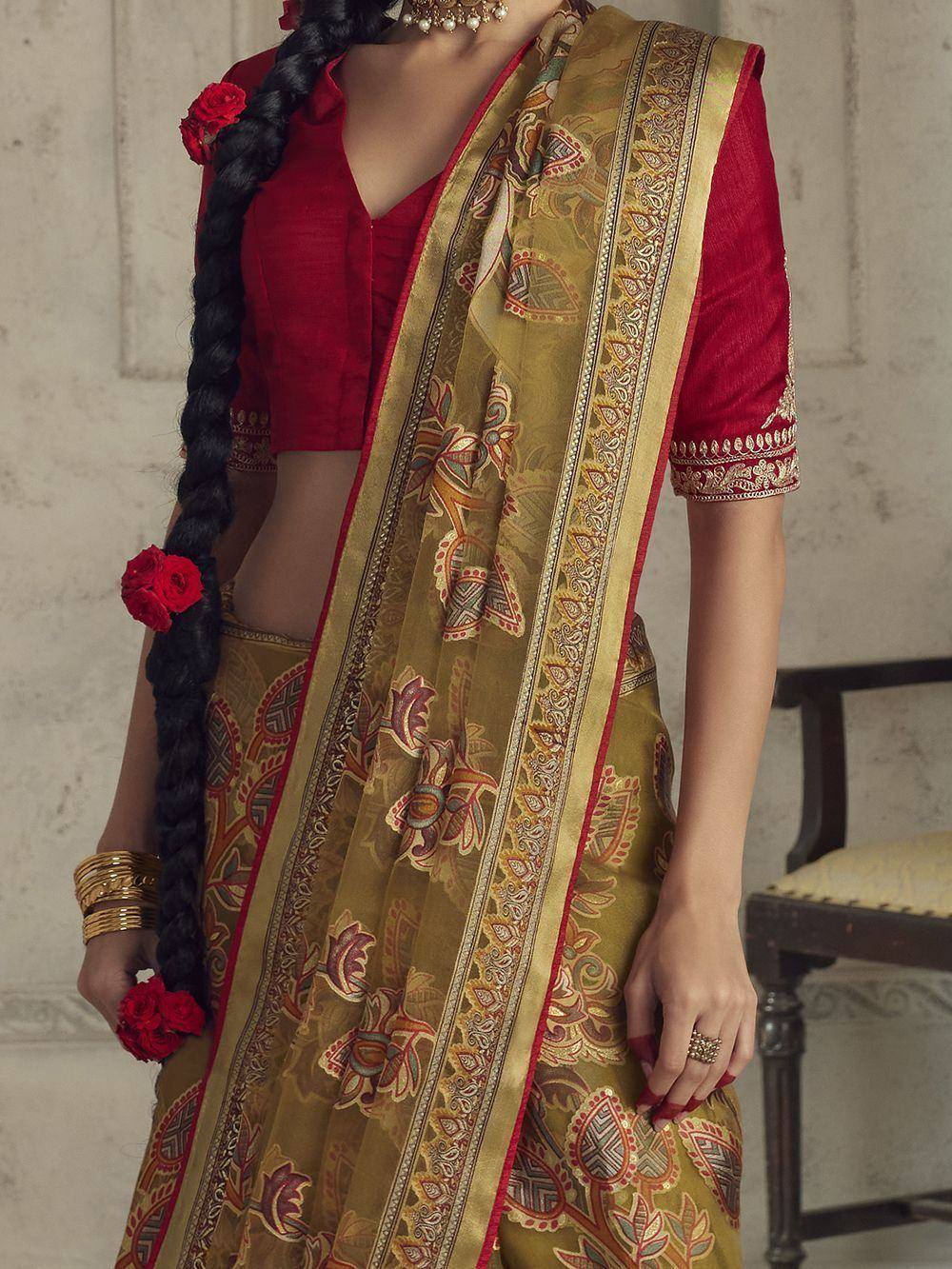 Elegant Indian saree with gold paisley print, red blouse, and floral hair accessories for ethnic wear