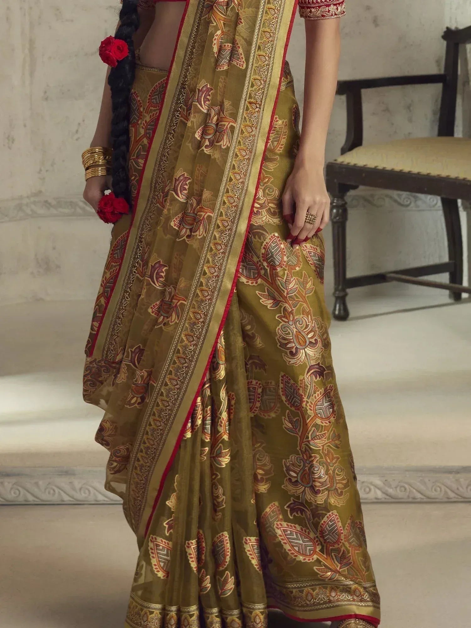 Olive green floral print saree with gold border, red accents, and traditional Indian embroidery