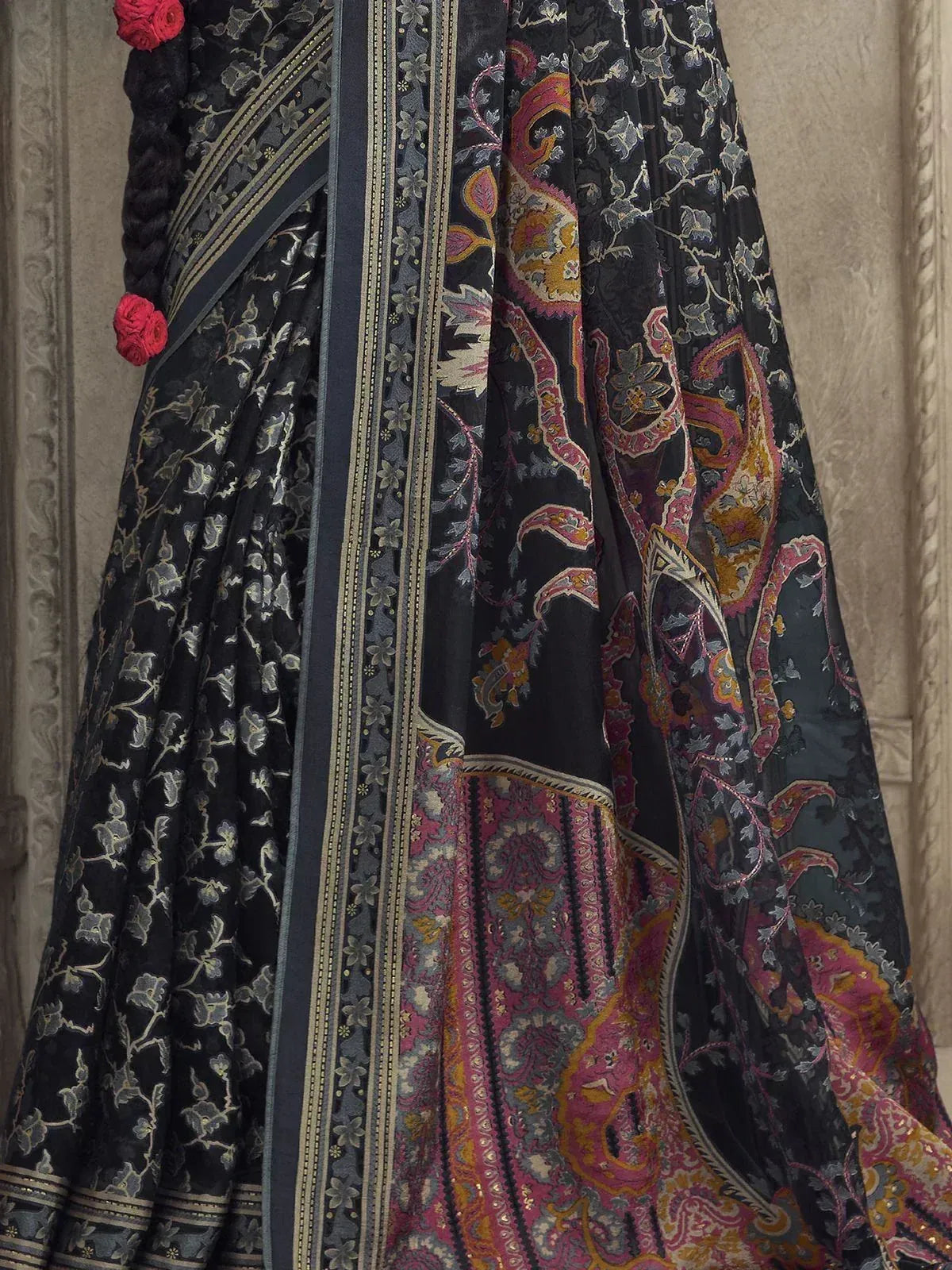 Black floral and paisley print lehenga choli with embroidered border and red floral accents