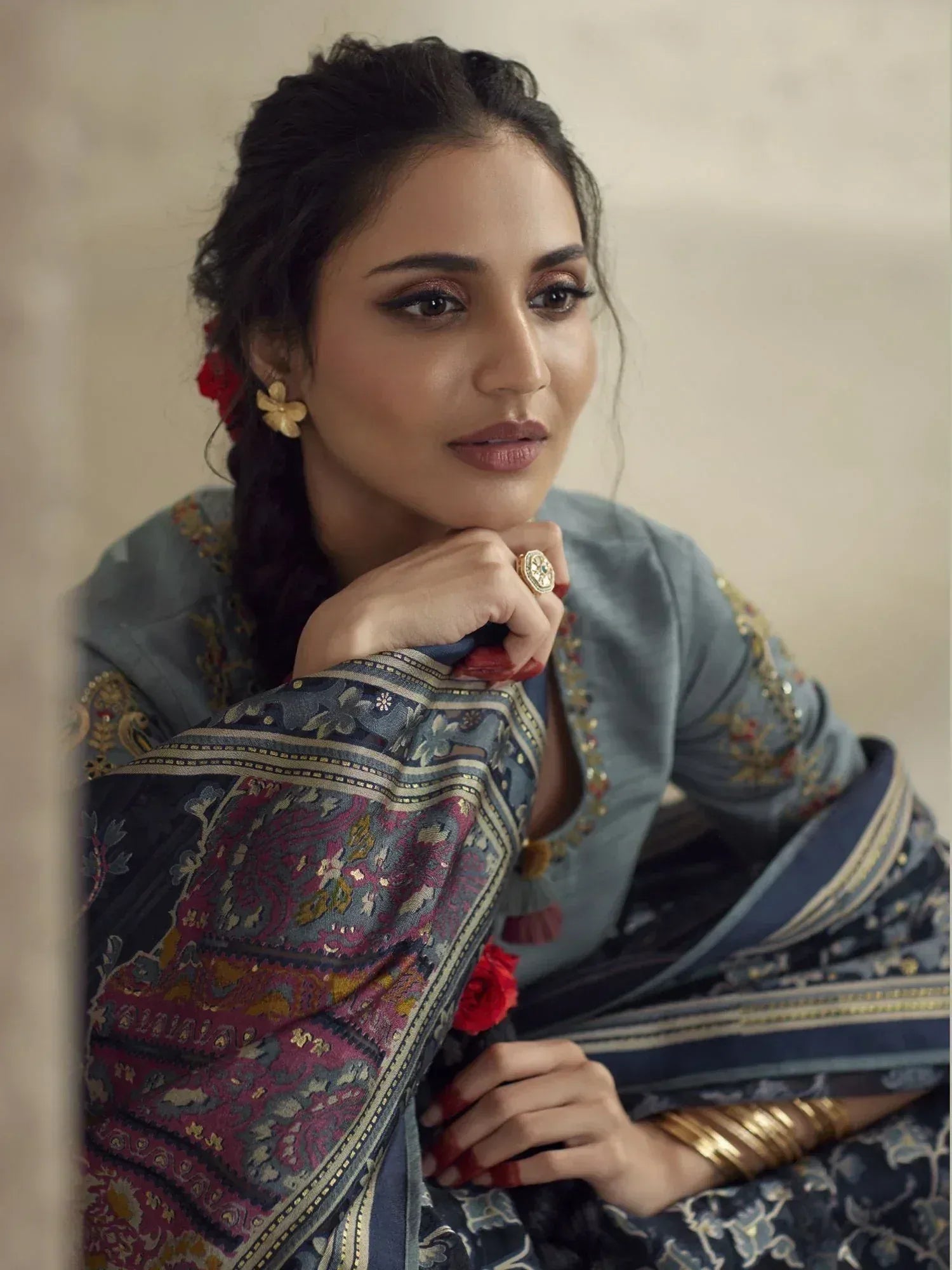 Woman in elegant Indian ethnic wear with floral embroidery and traditional jewelry