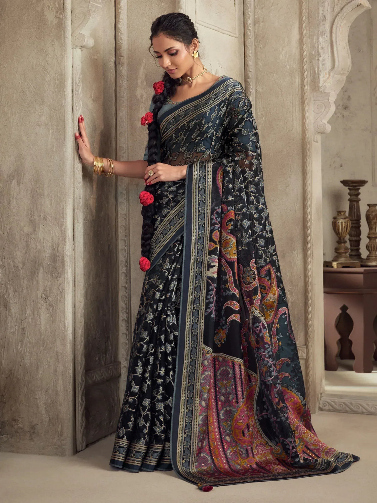 Elegant black saree with floral and paisley print, perfect for Indian ethnic wear occasions.
