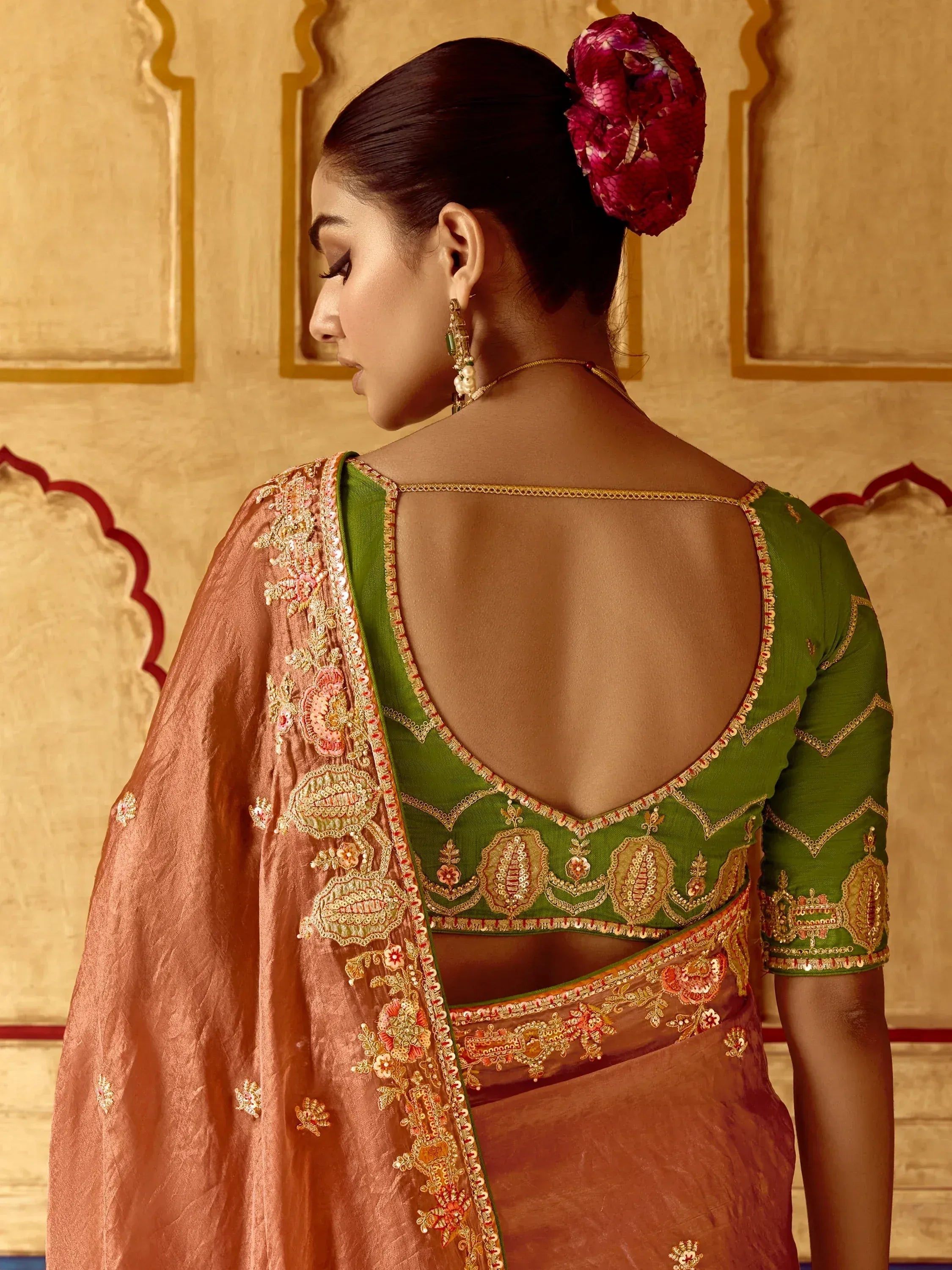 Green embroidered blouse with back cutout, paired with peach saree, Indian ethnic wear