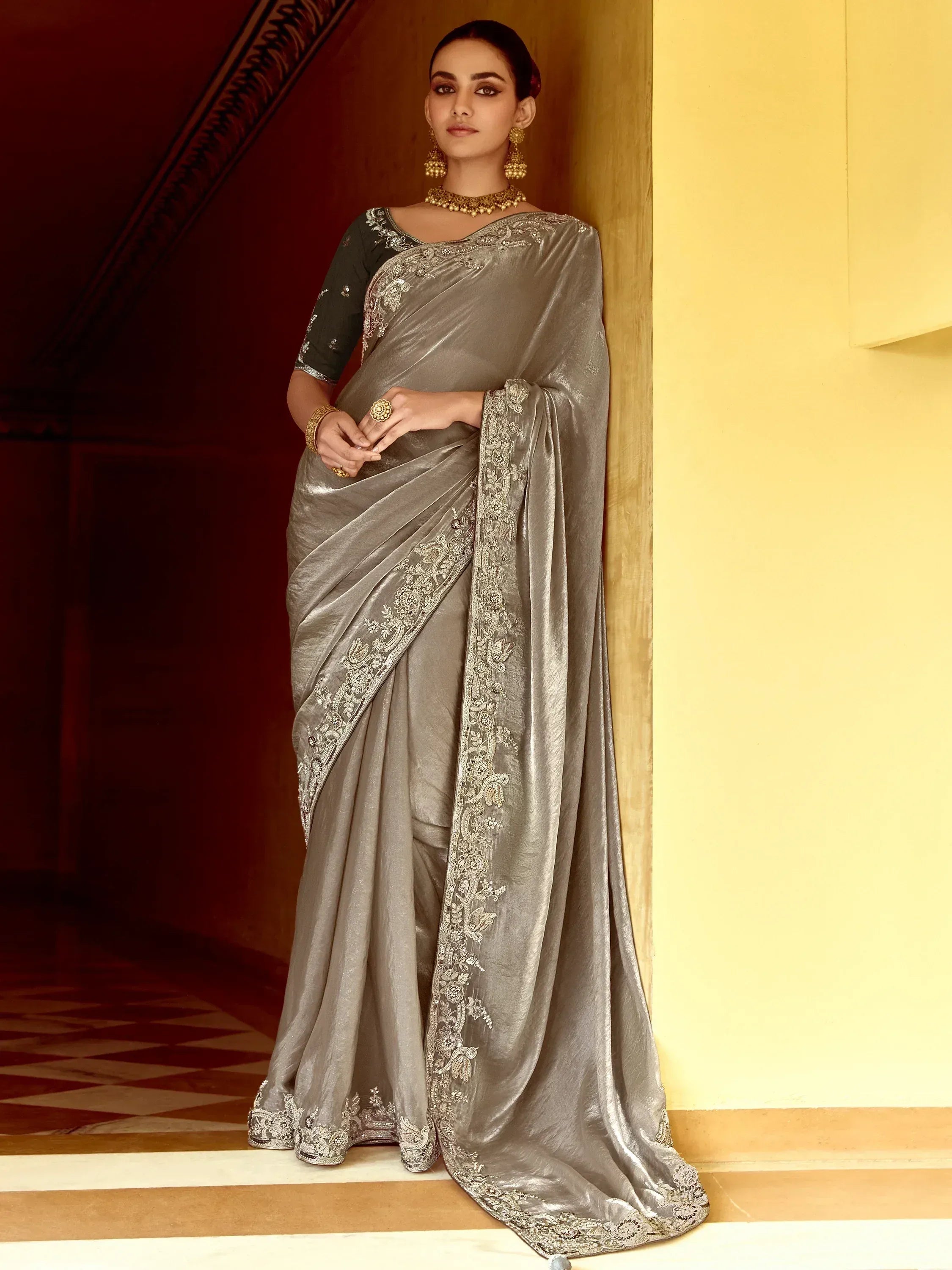 Elegant grey saree with intricate embroidery and golden jewelry for Indian ethnic wear