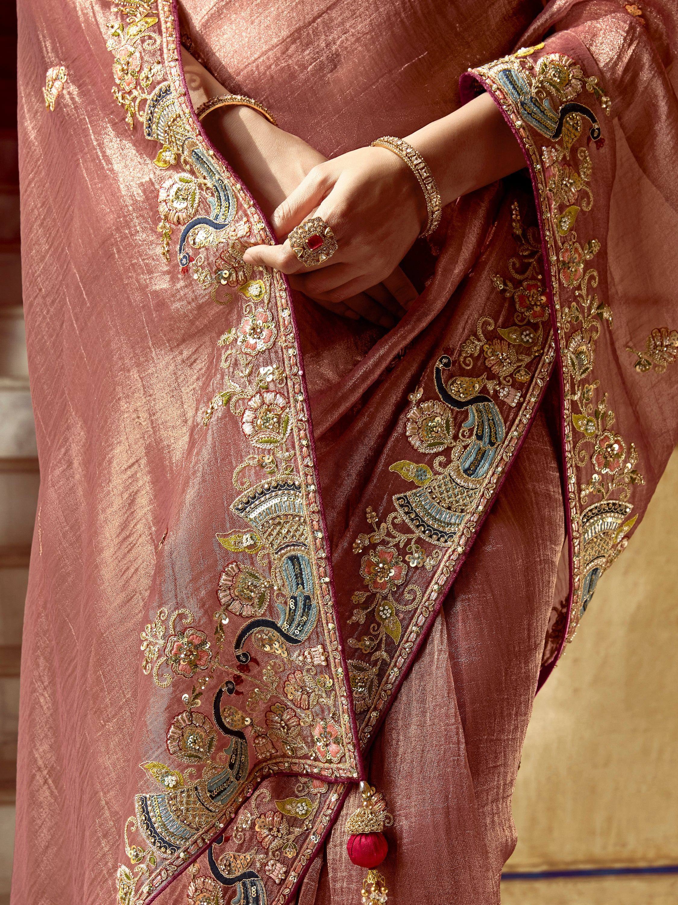 Elegant pink saree with peacock embroidery and gold detailing, perfect for Indian ethnic wear.