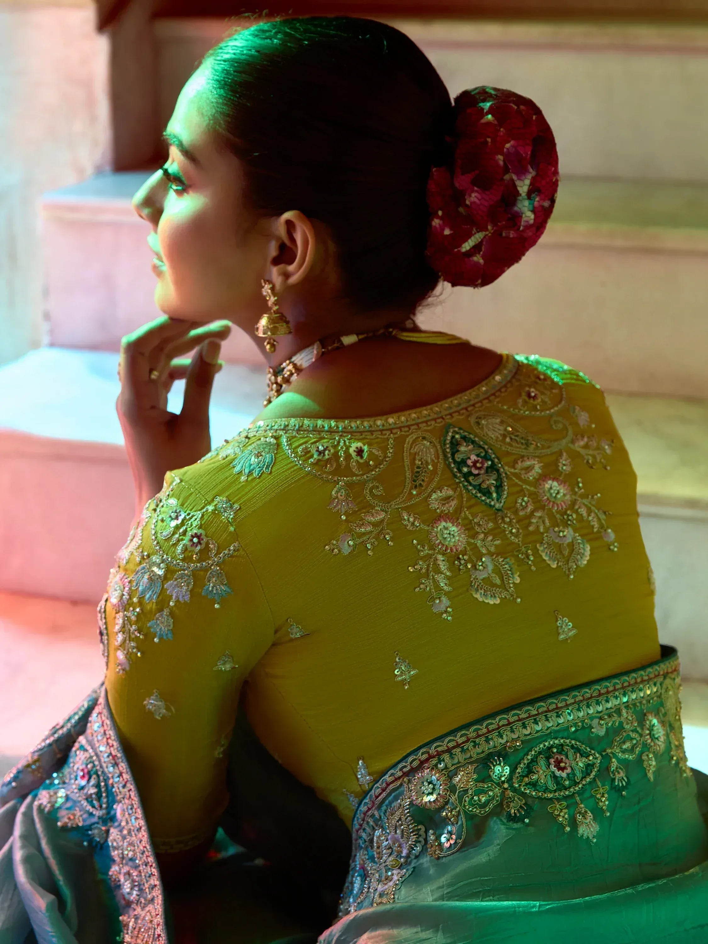 Elegant yellow and green embroidered lehenga choli with floral detailing and traditional jewelry