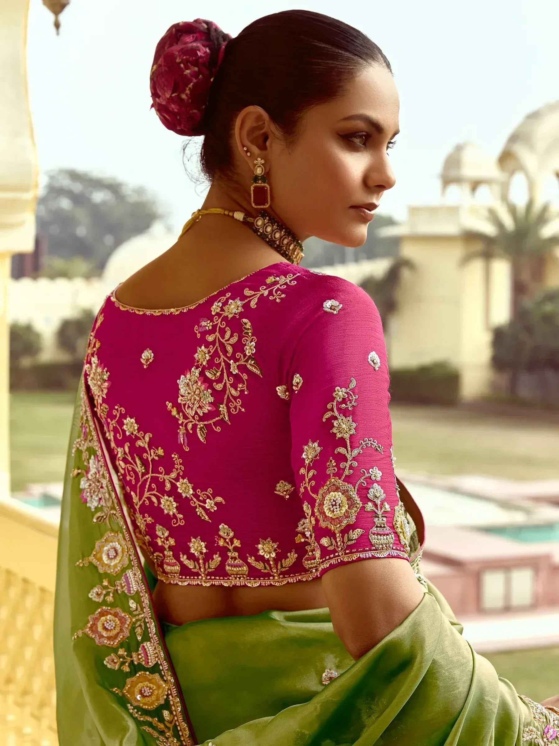 Elegant pink and green saree with intricate gold embroidery, perfect for Indian ethnic wear.