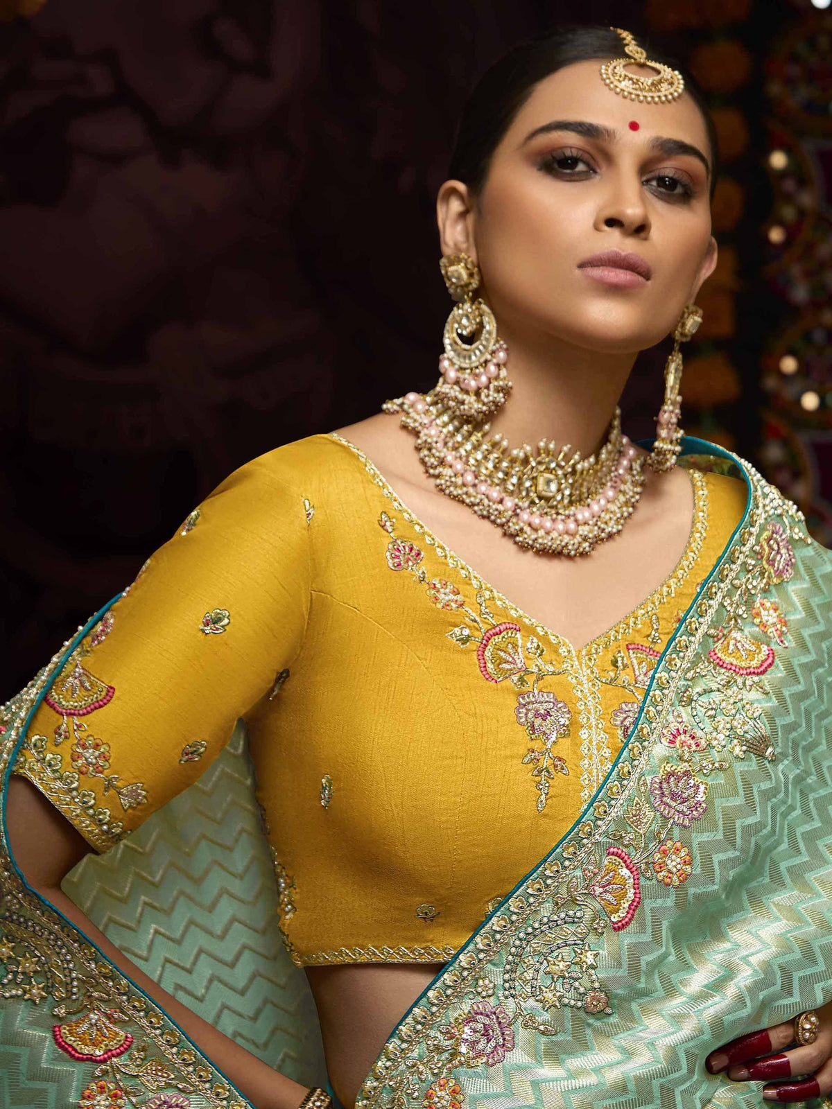 Yellow embroidered blouse with mint green saree, traditional Indian ethnic wear, designer jewelry