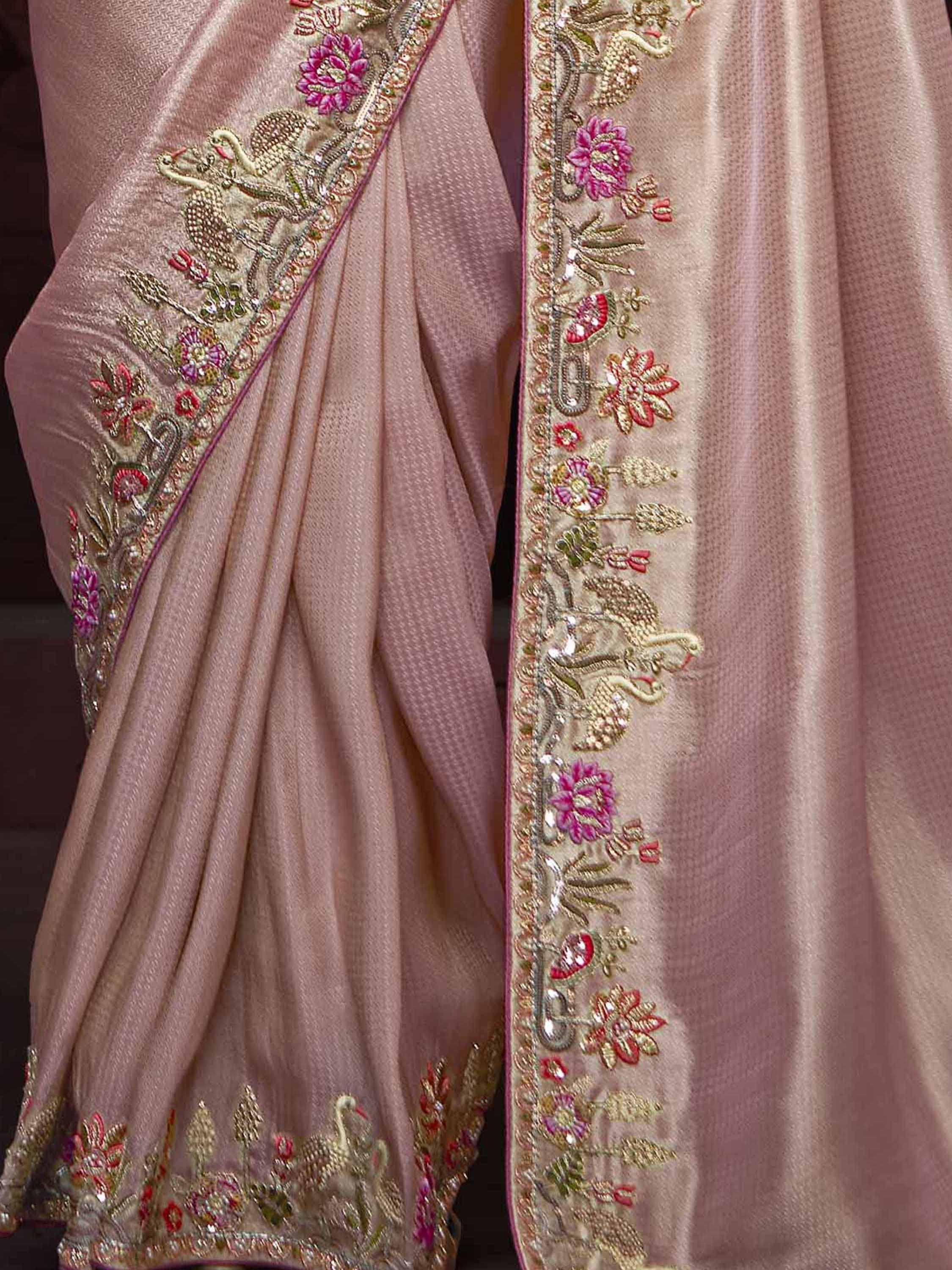 Pink saree with intricate gold and pink floral embroidery, perfect for Indian ethnic wear occasions.