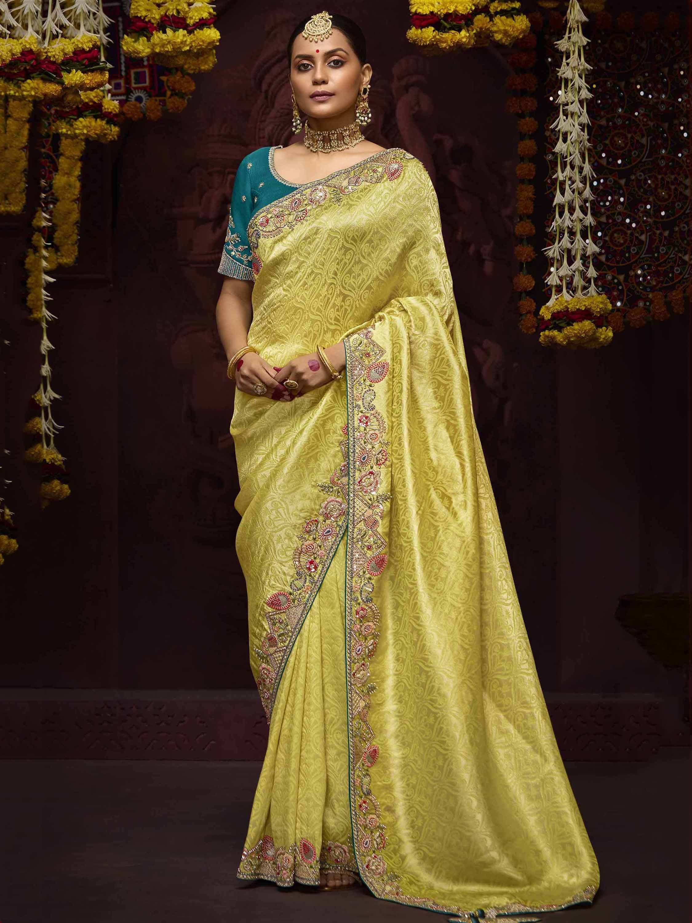 Yellow embroidered saree with teal blouse, traditional Indian ethnic wear for festive occasions