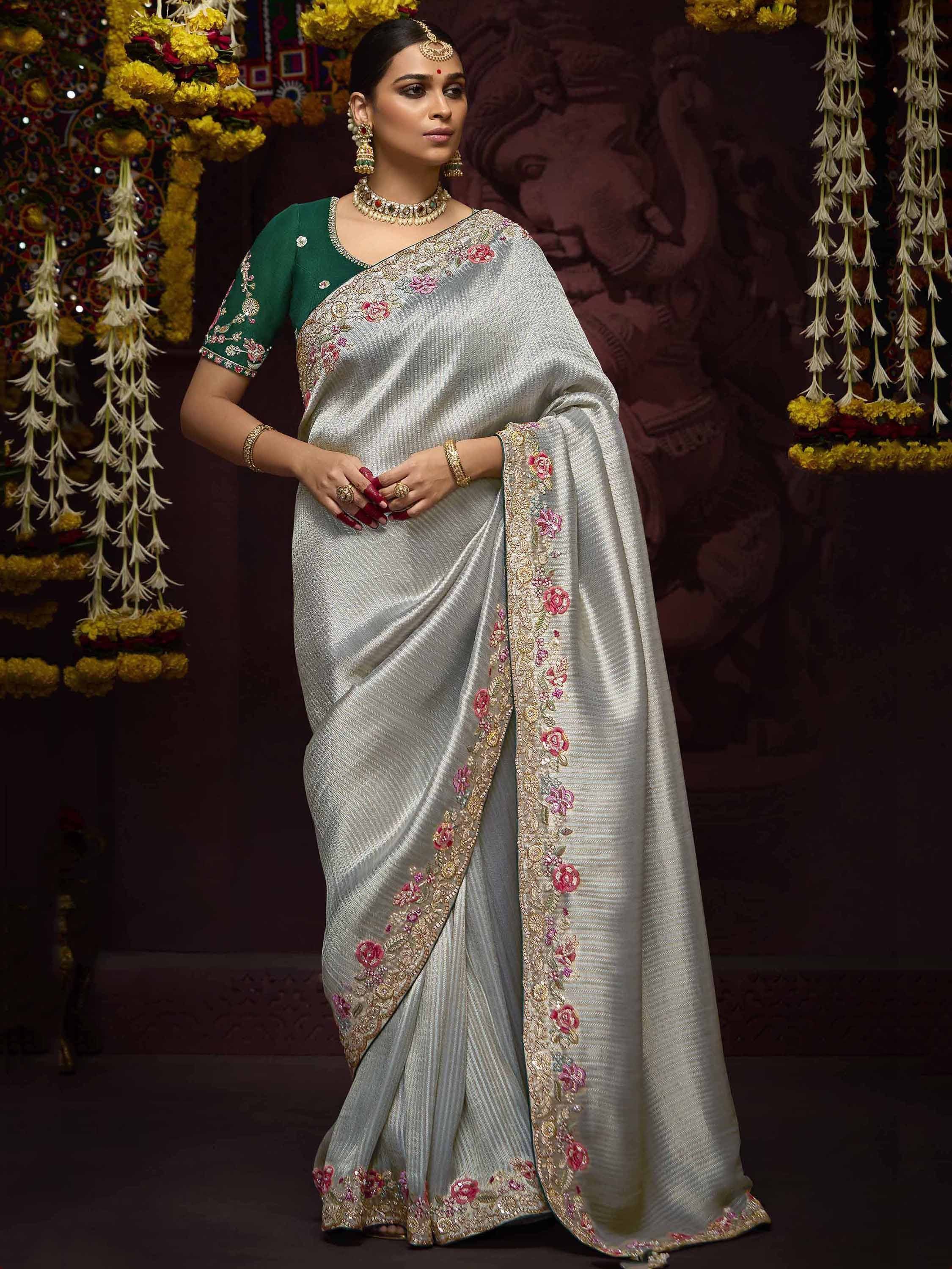 Elegant silver saree with floral embroidery and green blouse, perfect for Indian ethnic occasions.