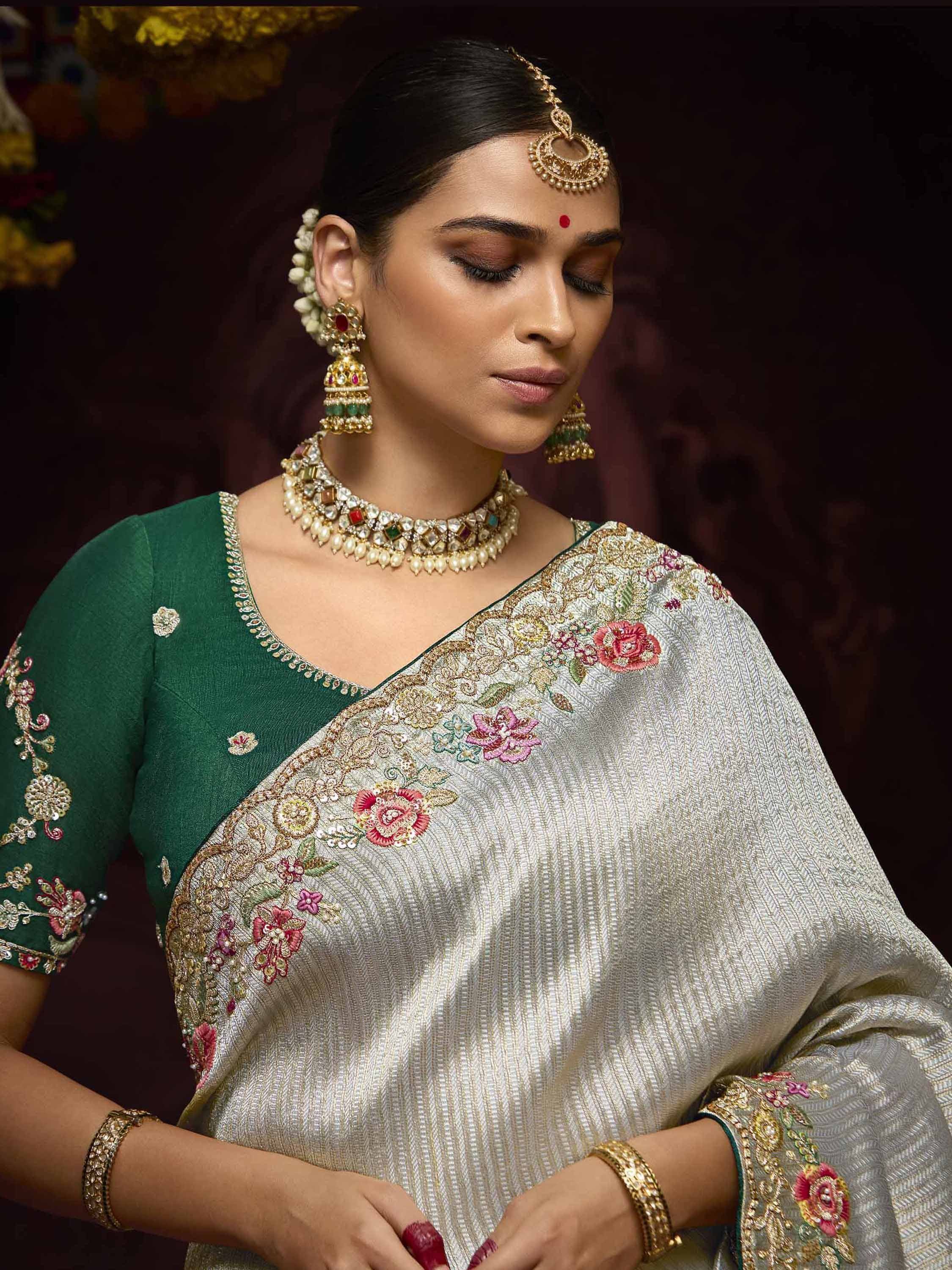 Elegant Indian saree with floral embroidery, green blouse, and traditional jewelry for ethnic wear