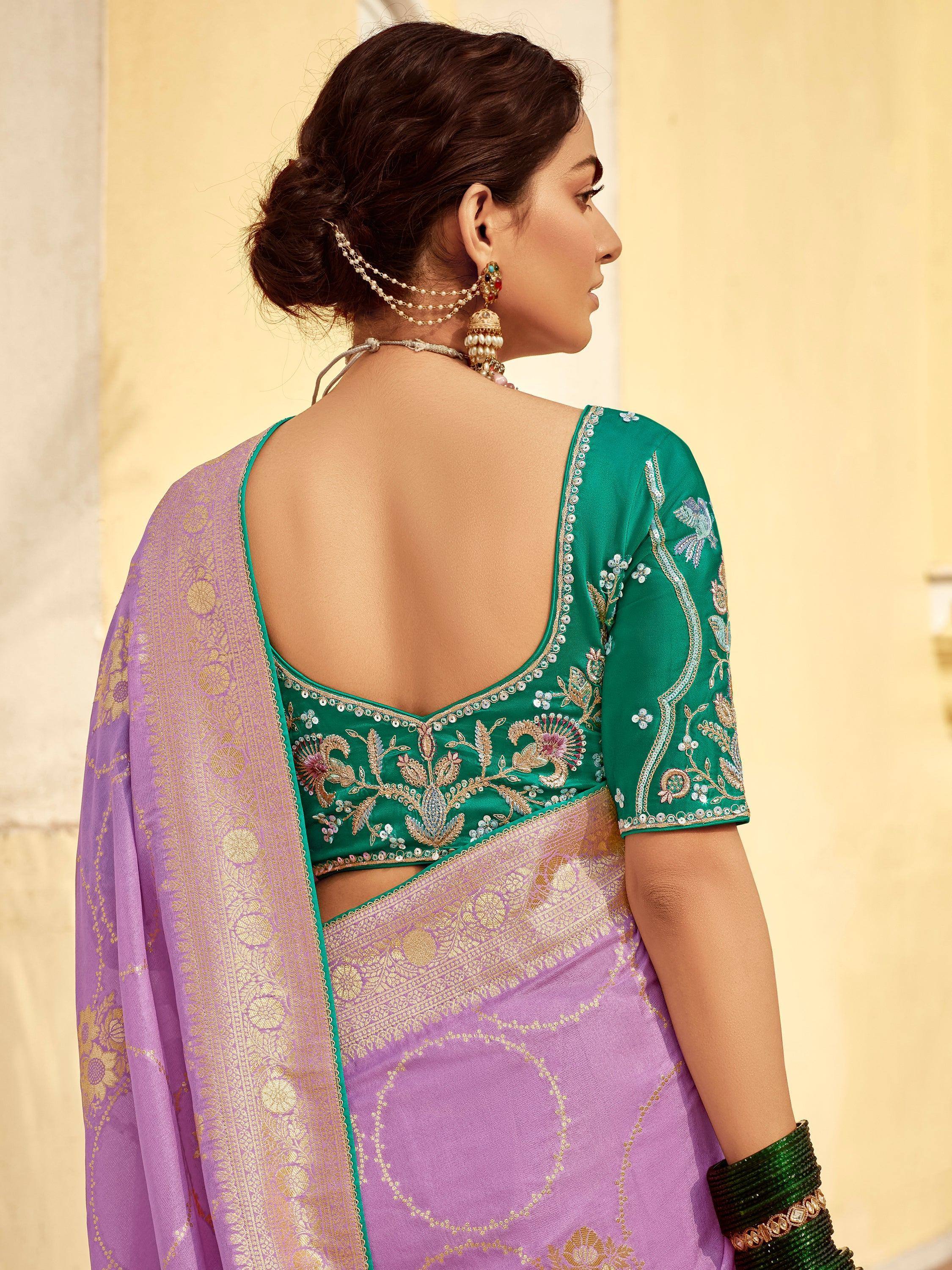 Lavender saree with gold zari work paired with emerald green embroidered blouse, perfect for Indian ethnic occasions.
