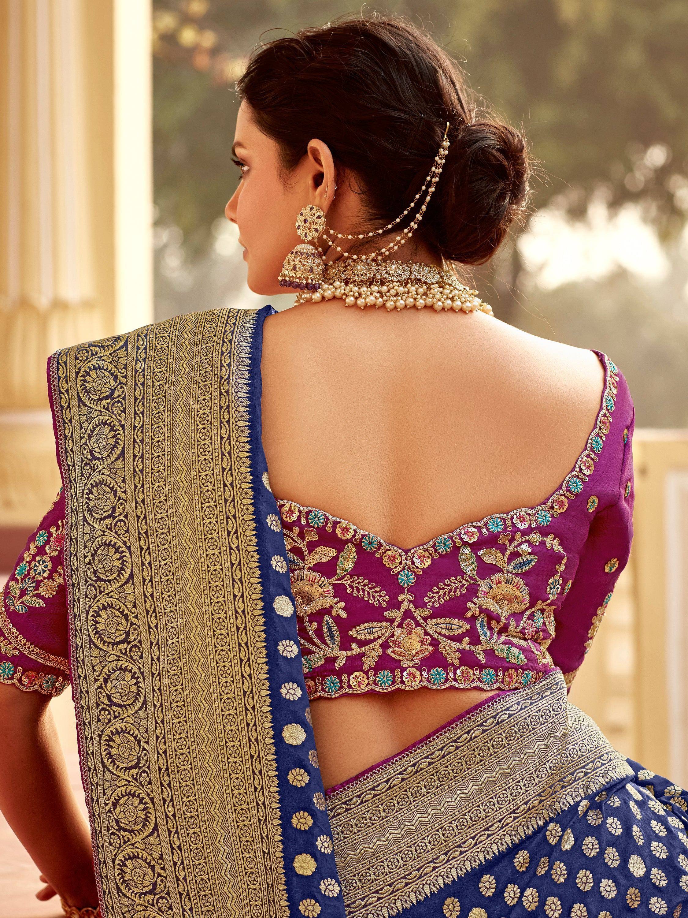 Purple and blue embroidered saree with floral blouse and gold jewelry